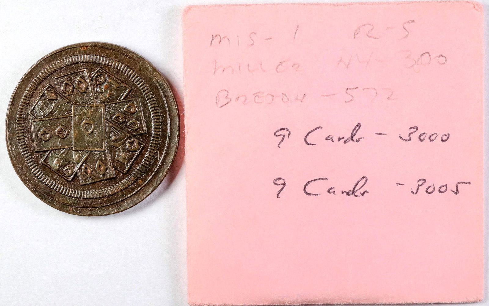Rare Counter with Nine Cards Each Side (120146): Nine playing cards on each side of this counter. Br., rd., 30 mm. Nines is a trick-taking game played with a standard deck of 52 playing cards. Nines is played by three people, and the object is to lo