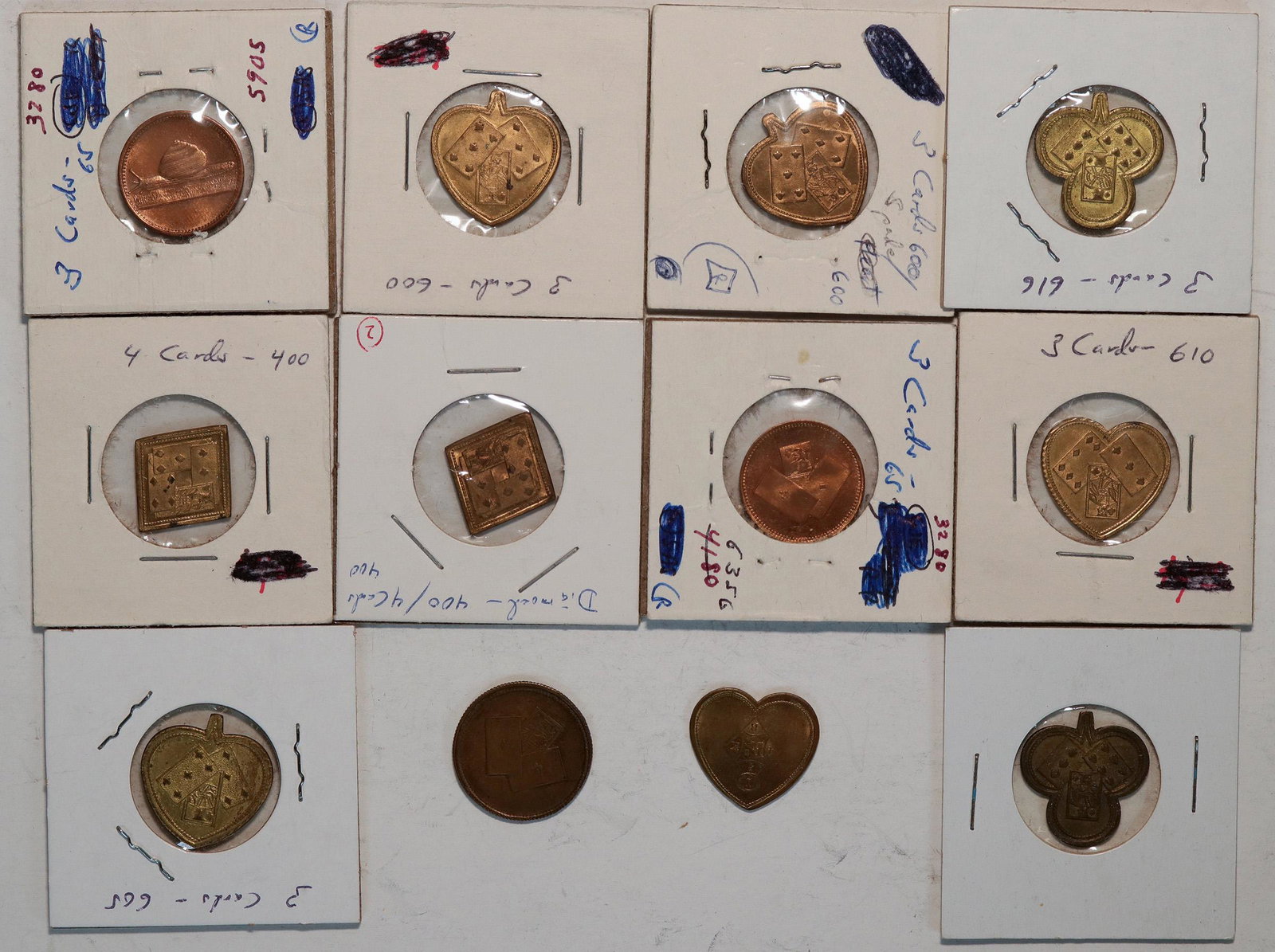 Three and Four Card Counters (121426): Lot of twelve tokens. Nine in the shape of suits: 2 clubs, 2 diamonds, 2 hearts, 3 spades. Three 3 card tokens: one snail, one fish reverse, one with playing cards both sides.Date: Country if not USA: