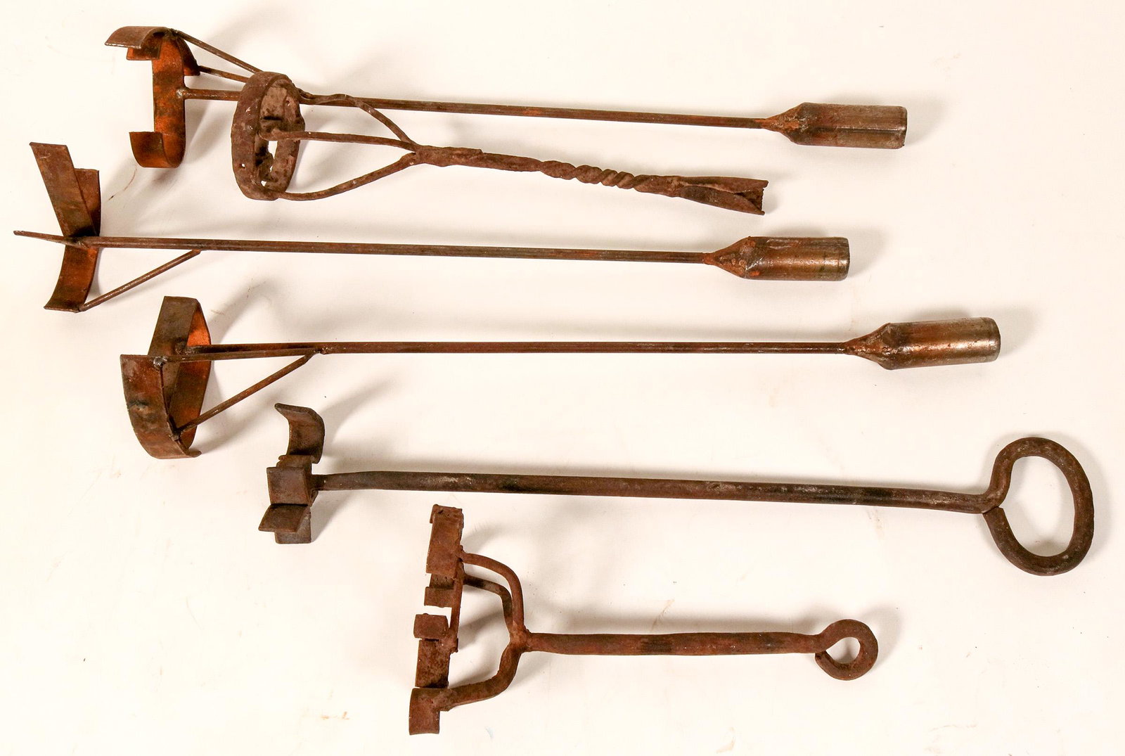 Six Multi-Letter Branding Irons (109795): Six multi-letter branding irons, between 11 and 24 inches long. Patterns include Rocking C, Rocking D, Rocking V, X-bar-J, S-curly-H, and Circle-VC. All have well-developed patina of rust that will su