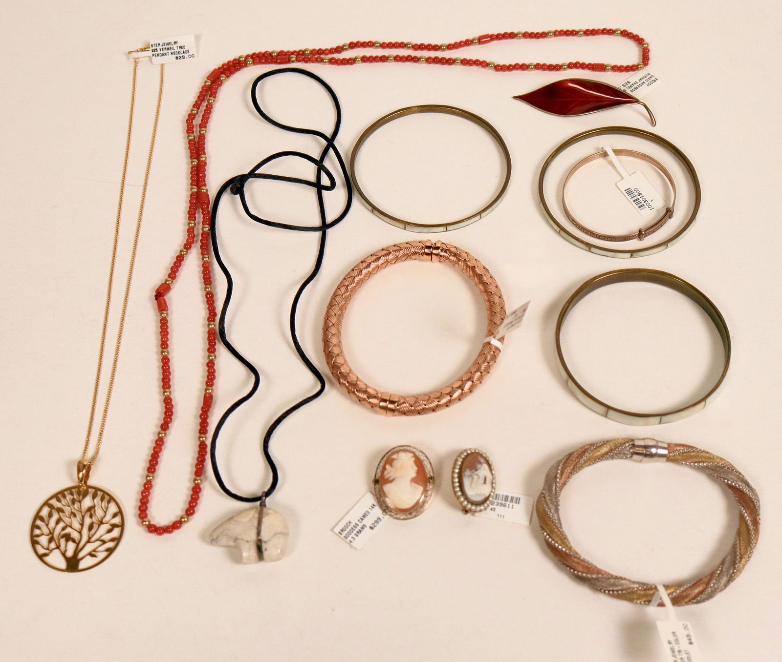 Baubles, Bangles & Beads (121532): A unique collection of bracelets, beads, cameos, pendants and lanyards. Total weight of the various and sundry items is 116.4 Grams. All are in good condition. See photos for more details.Date: Countr