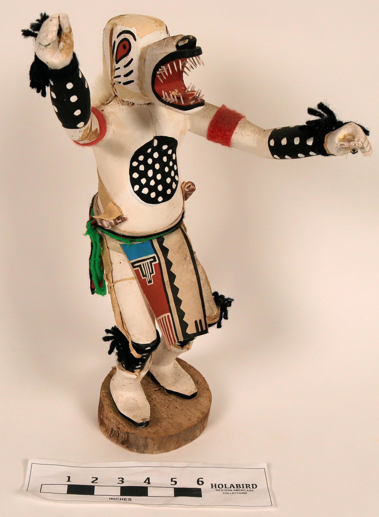 Navajo Wolf Kachina Doll (122772): Navajo wold kachina. It stands about 19" tall, with outstretched arm. It has leather loin cloth that is brightly painted. It appears that the fur that was supposed to be on the head is missing. See ph