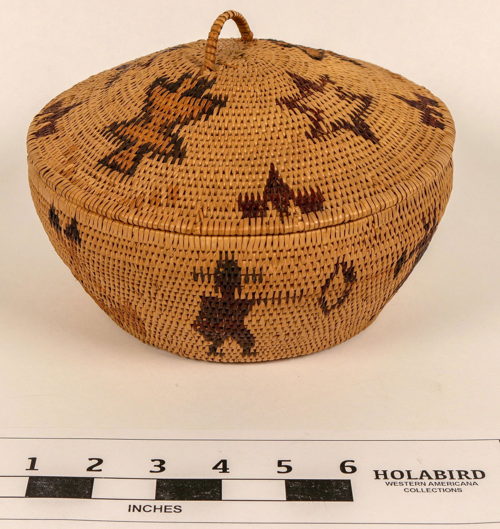 Figural Polychrome Lidded Washoe Basket (124481): Classic pictorial basket of the Sara Mayo Era. Diameter 8" x 6.5" Tall. Polychrome with figures along the edge of Native American with bow and arrow hunting deer, Native American lady with bird. Brack