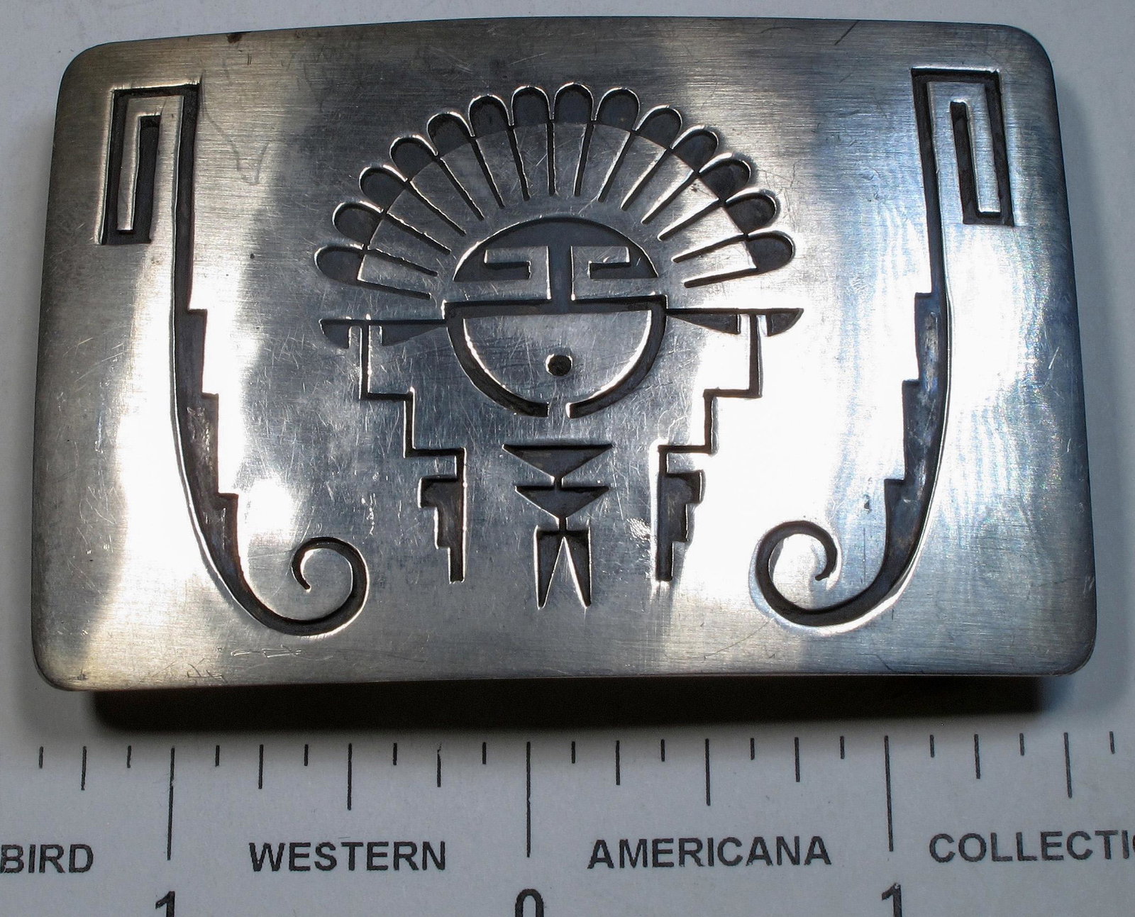 Hopi Sun Face Belt Buckle (125241): This is another vintage Hopi belt buckle with a sunface design and measuring about 2[x=#8221/] tall by about 2 [x=#190/][x=#8221/] wide for a 1 [x=#189/][x=#8221/] belt.Date: Country (if not USA): Sta