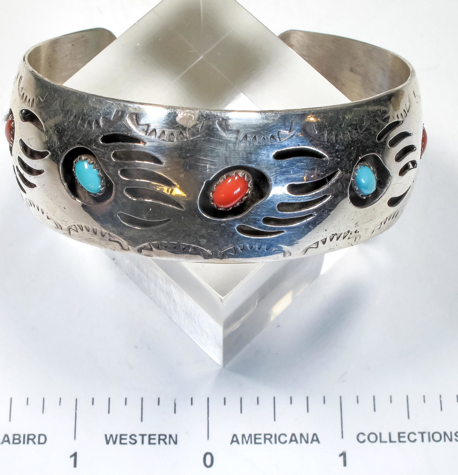 Navajo Turquoise and Coral Bracelet (125160): This is a Navajo signed Pearlene Spencer sterling silver bracelet with a bear claw track motif in a shadow box style with alternating turquoise and coral stones set in each bear track, the width of th