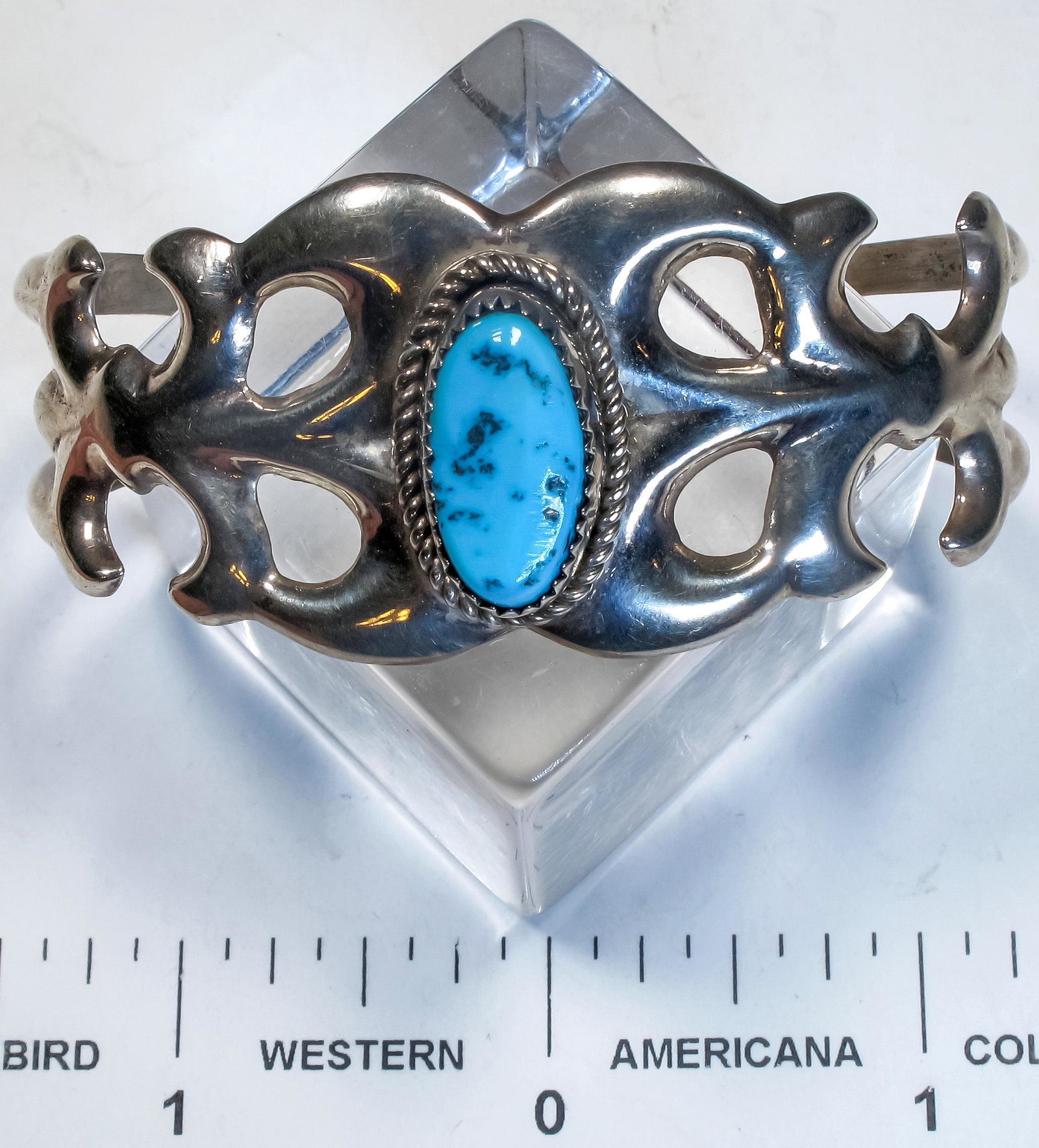 F.L Begay Tufa Cast Bracelet (125162): This is a tufa cast sterling silver bracelet set with a single turquoise stone and signed by Navajo silversmith F.L. Begay.Date: Country (if not USA): State: City: Provenance: