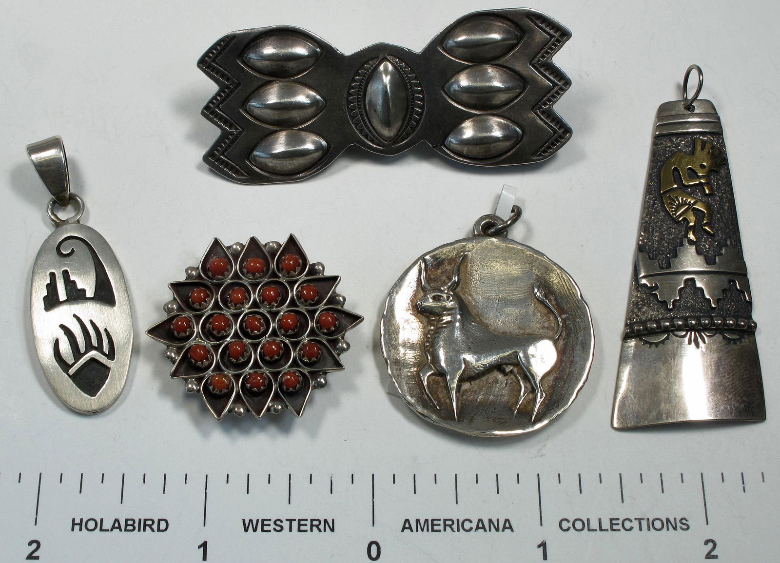 Native American Pendants (4) (124870): 1) Gold Kokopelli on incised silver mountains. Hallmarked Thomas Singer. 2.25" x 1". 2) Hopi style, made in Mexico incised bear claw, mountains. 1.25" x 3/8" oval. 3) Zuni sun, set with coral petit po