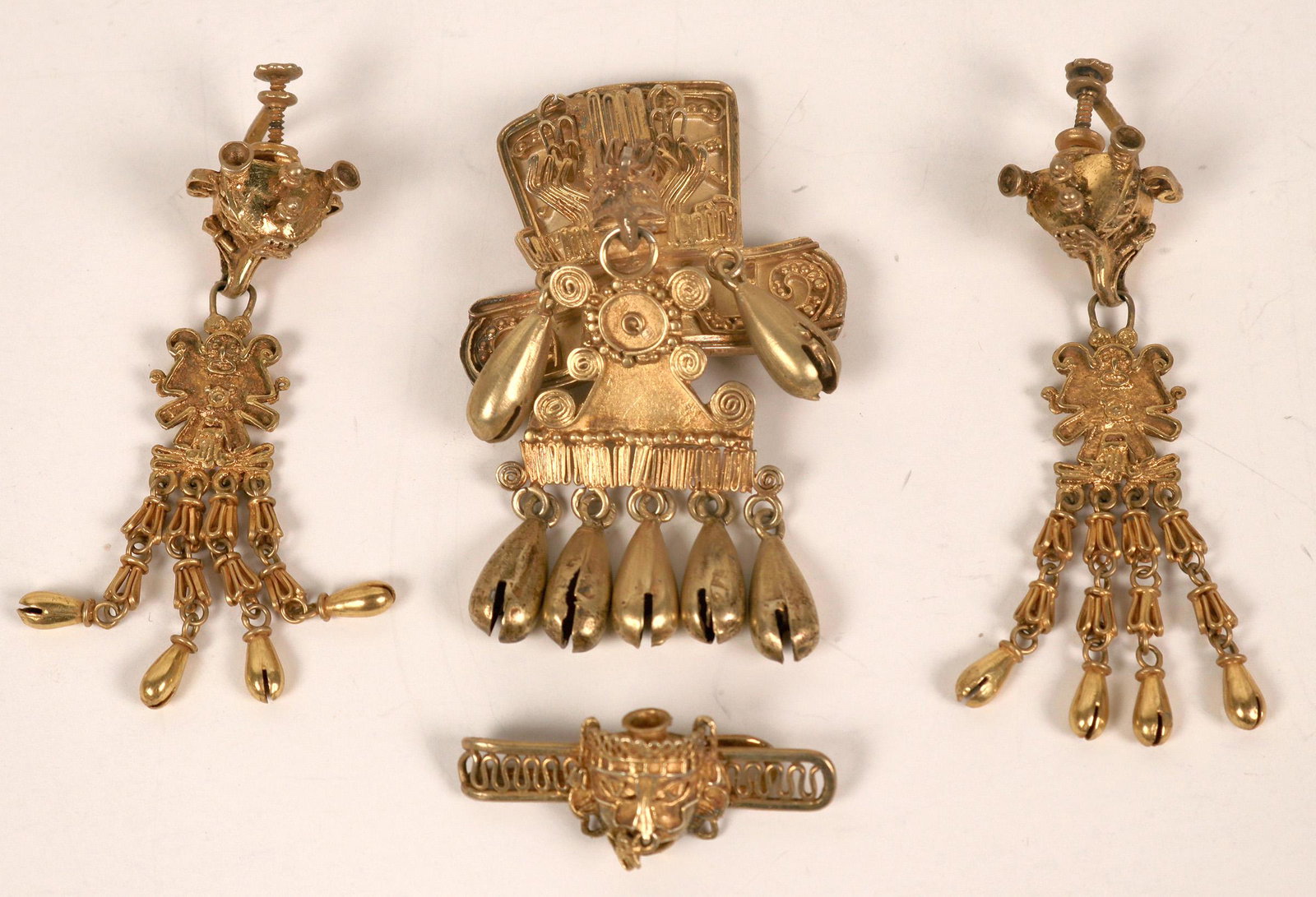 Peruvian Gold on Sterling Jewelry (124092): Unique Four piece jewelry with Inca style artwork. Pin/brooch, tie bar, and a pair of earrings. Date: Country (if not USA): State: City: Provenance: Salvatore Falcone Collection