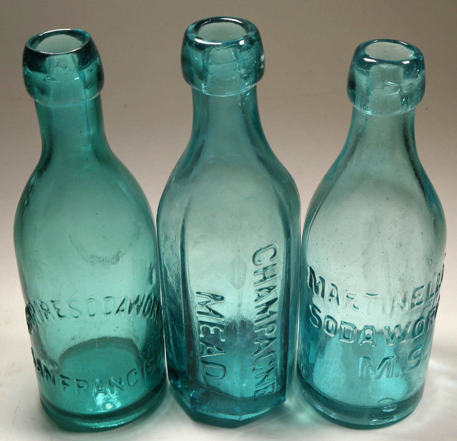 California Deep Aqua Blob Soda Group (124830): Empire SW, deep aqua; Martinelli's (the same family as the apple cider and the great Napa wine); Champagne Mead (8 sides, a beauty and classic California soda bottle). All clean and near mint.Date: Co