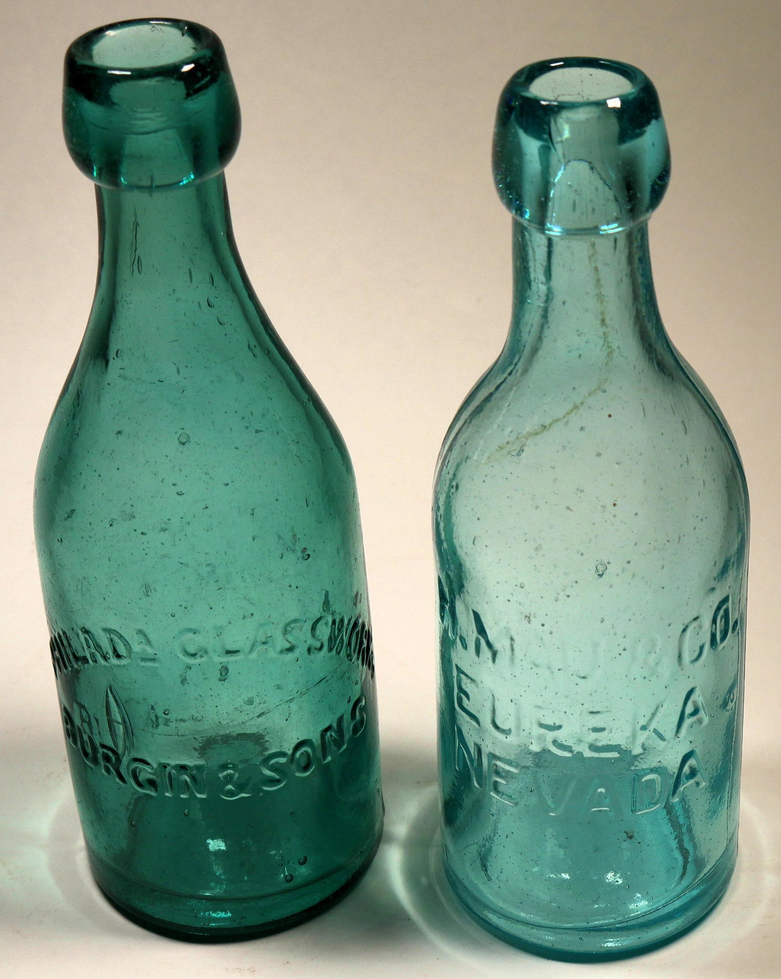 Mau, Eureka, Nevada Blob Soda +1 (125145): Classic H Mau and Company, Eureka NV blob soda with western style lettering. This is the only blob soda from Nevada with the name Nevada spelled out. Aqua mint. Comes with Philadelphia Glass works, Bu