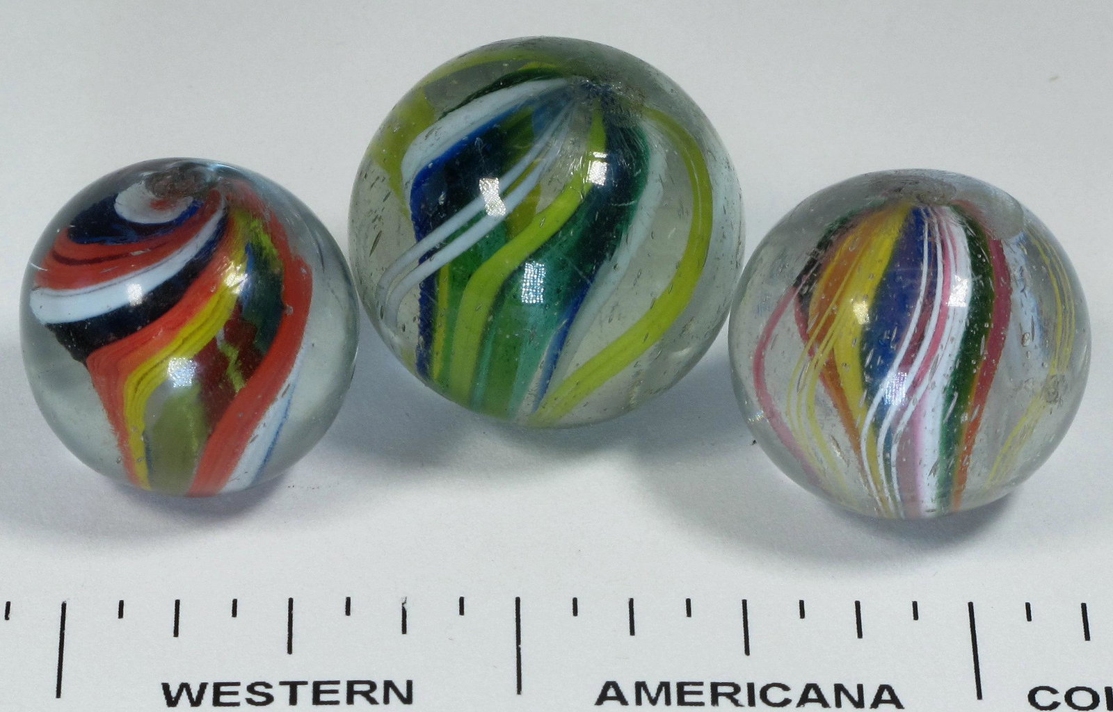 Ribbon Cores (3) (125360): 1. 5/8" blue/white, green/yellow inner panels. The blue and green canes are translucent (jelly core) type. Surface glass problem free with a few very minor scratches. 2. 3/4" red/white/blue, yellow/re
