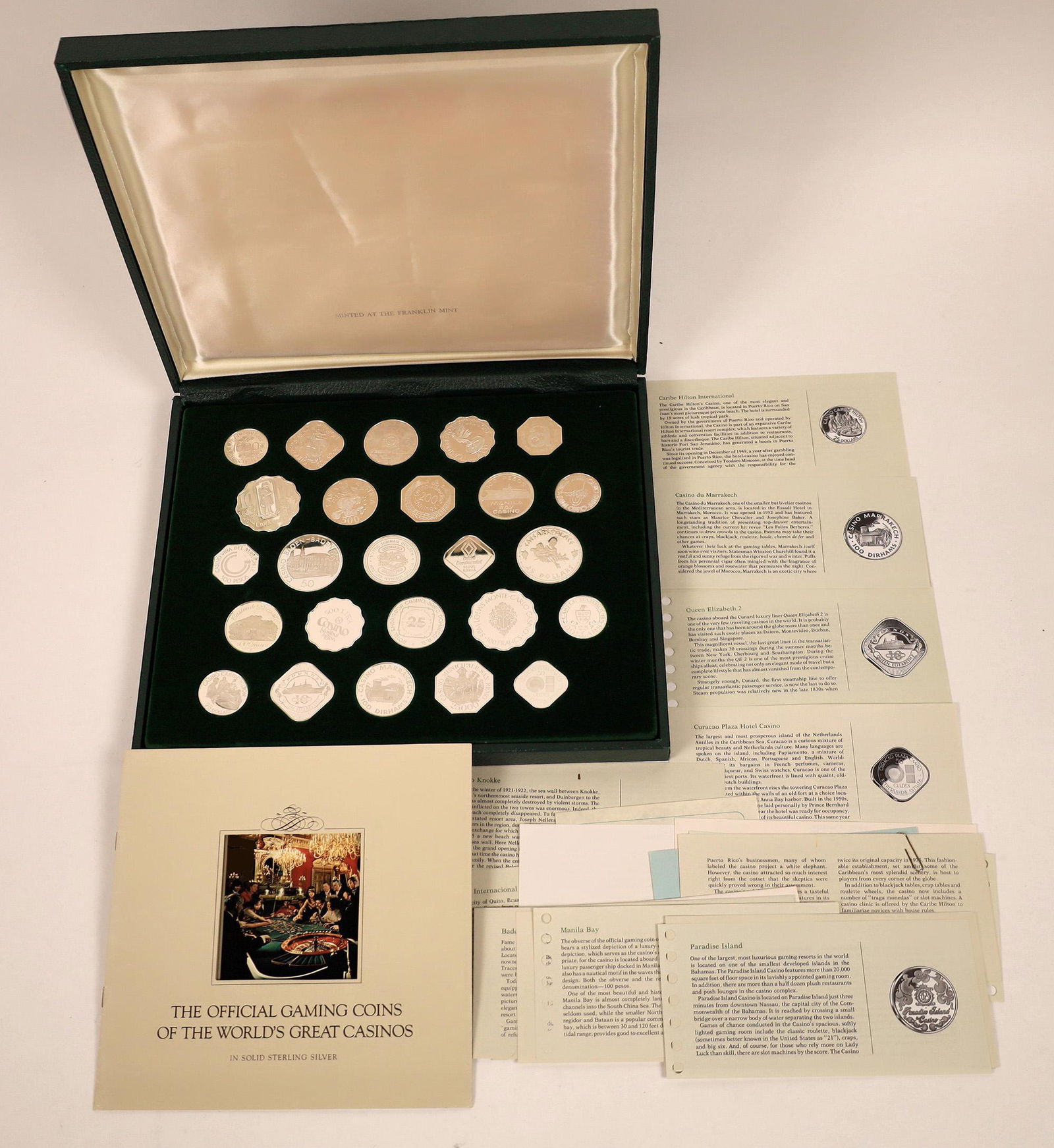 Official Gaming Coins of the World's Great Casinos (25: Franklin Mint issued set of 25 sterling silver proof gaming tokens from the worlds greatest casinos. The green case indicates the set was minted in 1978. Each coin is an official issue of one of the w