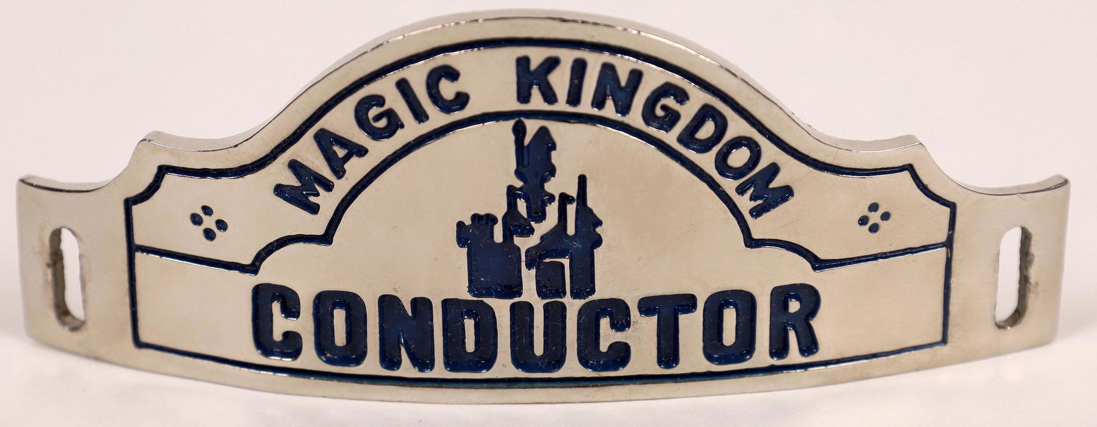 Disney Magic Kingdom Railway Conductor Hat Badge: Conductor Hat Badge for the Disney Magic Kingdom Railway. Highly polished, silver-toned (nickel?) with black enamel lettering. No reverse stamp. Approx. 4 x 1-5/8 inches.Date: Country (if not USA): St