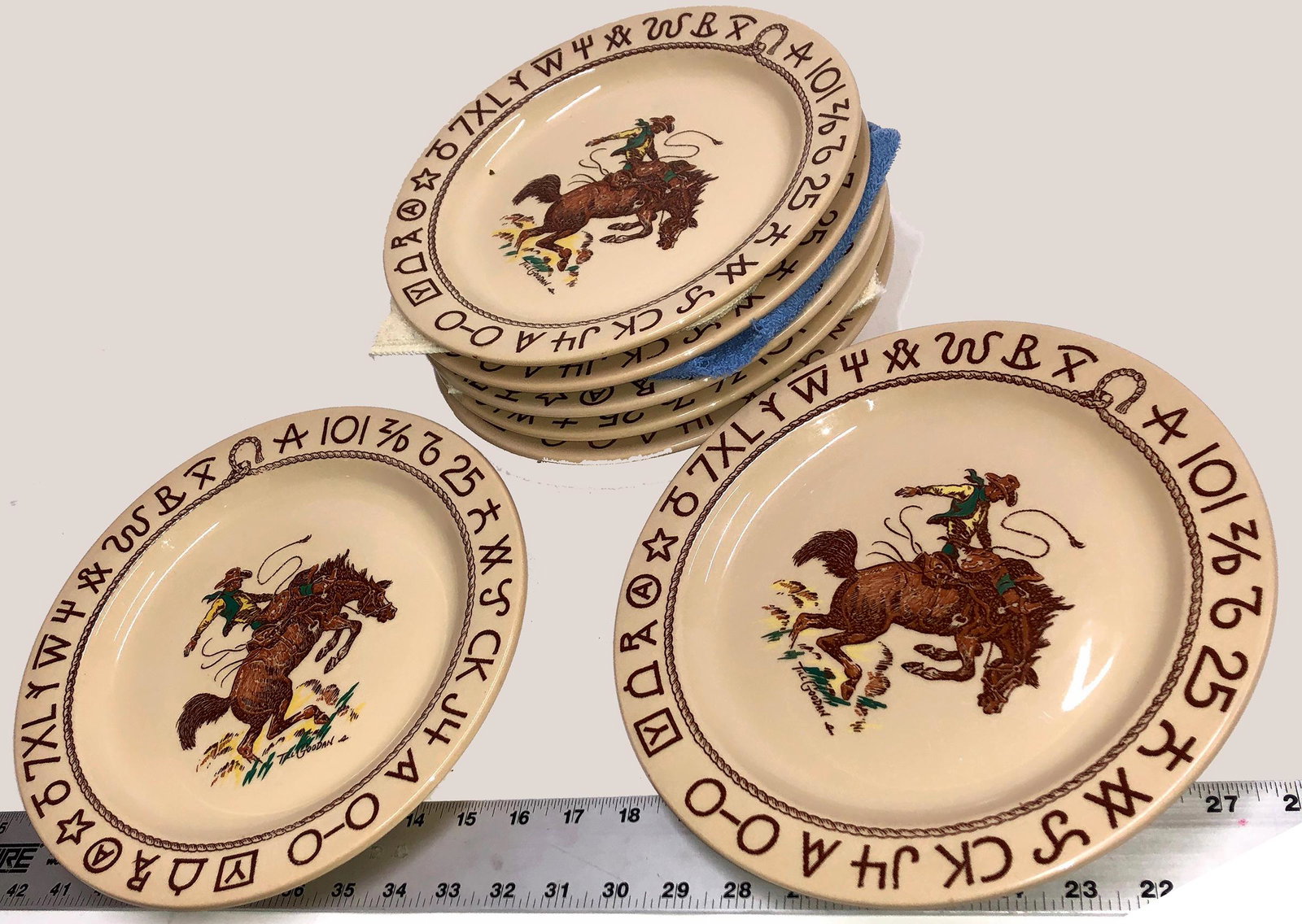 Westward Ho Rodeo Pattern Cowboy Plates [131261]: (7) 11" diameter plates featuring a bucking Bronco and Cowboy, designed by Till Goodan. Wallace china, Westward Ho Rodeo pattern, made in California. No chips or damage visible. Date: Country (if not 