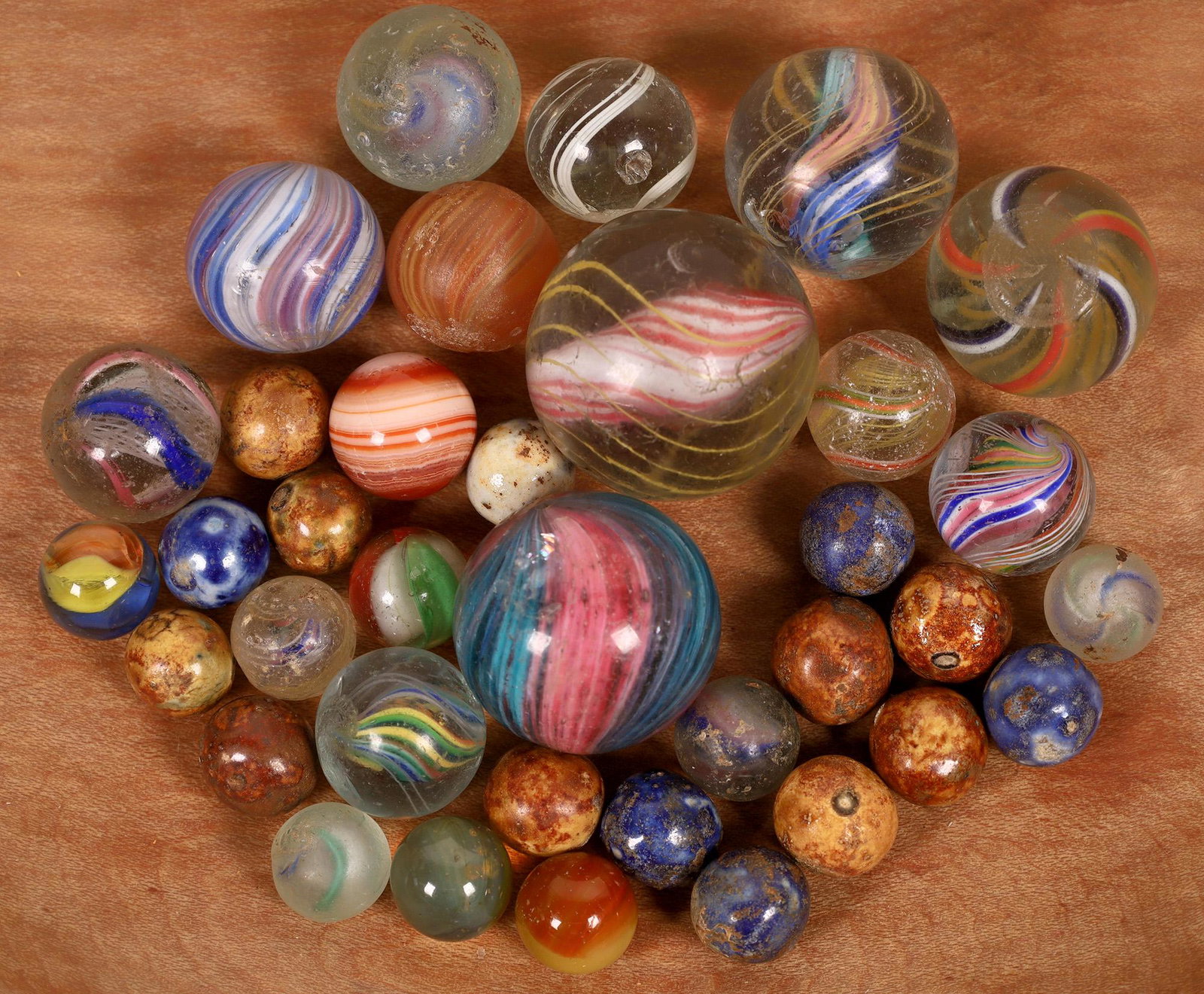Grab bag of Swirls and Benningtons [127832]: (12) Handmade swirls ranging in size from 5/8" to 1 1/8" in size. All have some surface issues, mostly minor. (15) Peewee Benningtons (3/8'), a couple of peewee swirls and one 1/2" faceted bullseye ag