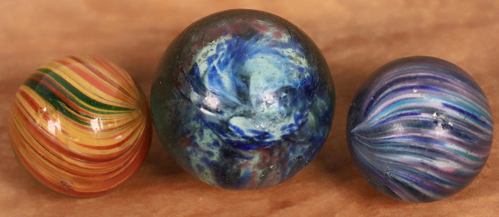 Onionskin marbles (3) [127822]: 1. 1 3/8" End of Cane - single pontil , paneled onionskin. Panels are blue/white and red/white. Marble has been lightly buffed around the middle, but pontil remained untouched. Still has several very 