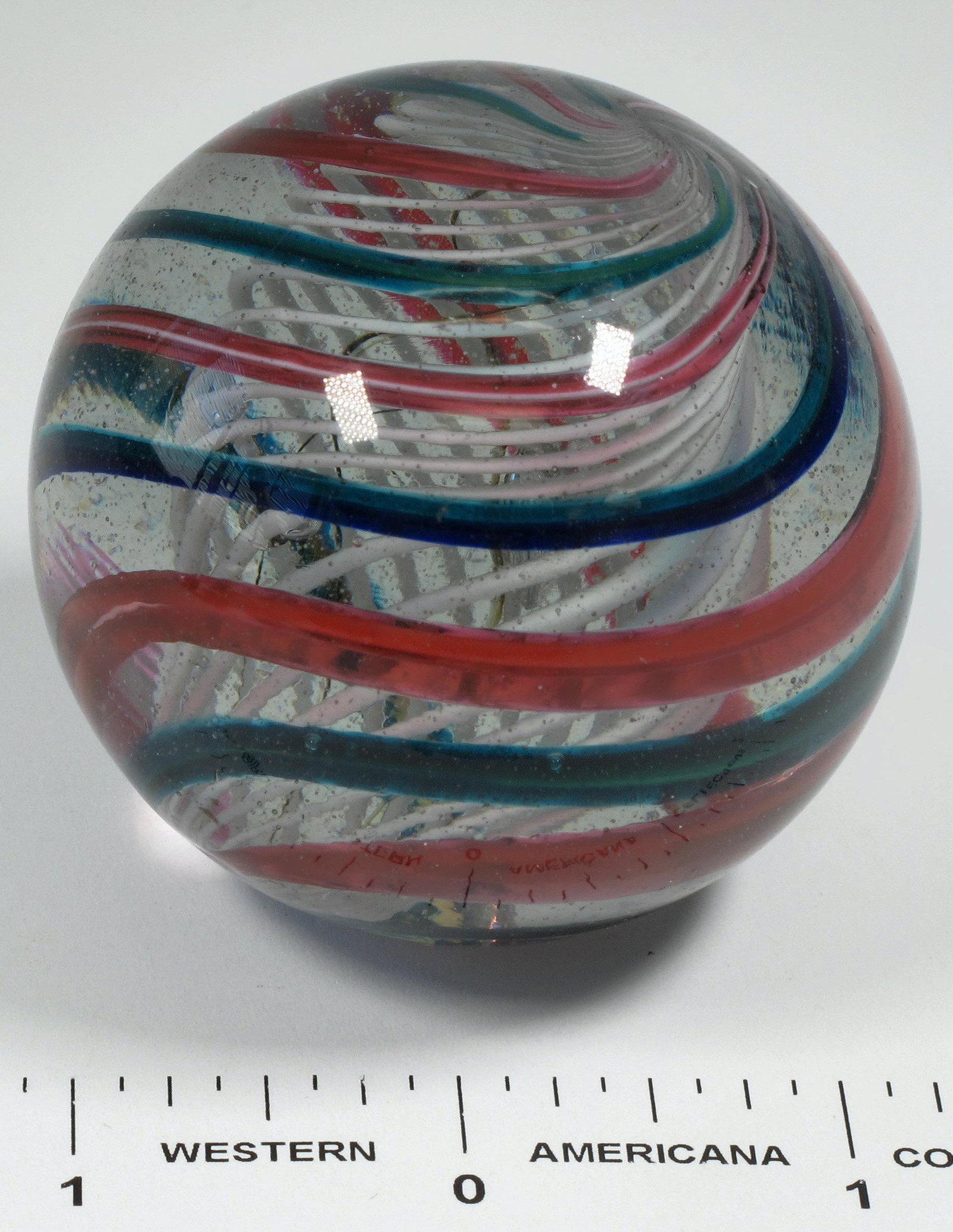 A Two Inch Toe Breaker Mammoth Glass Marble [125402]: This is a massive 2" "toe breaker" as they say in the marble trade. Explaining its colorful swirl pattern is futile, so I'd suggest just looking at the photos. No nicks or chips. Please see photos for