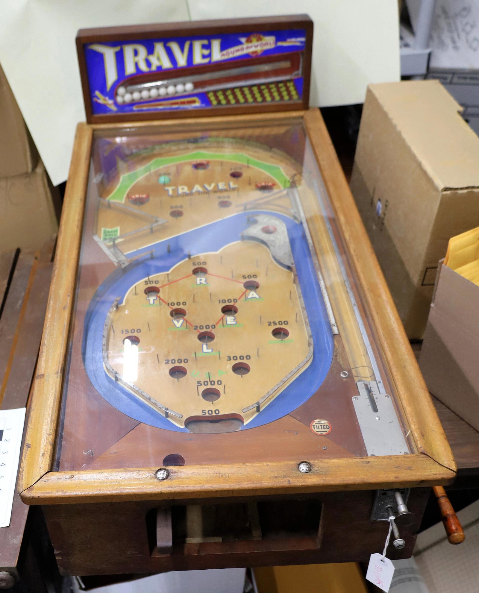 Travel Around the World 1935 Electro-Pinball Machine by: Rare 1935 electro-pinball machine by Peo, 42" long, 21" wide, 47" tall. Finished stained wood frame as original. If there was an equipment cover (doesnt look like it), it is not present. The "electron