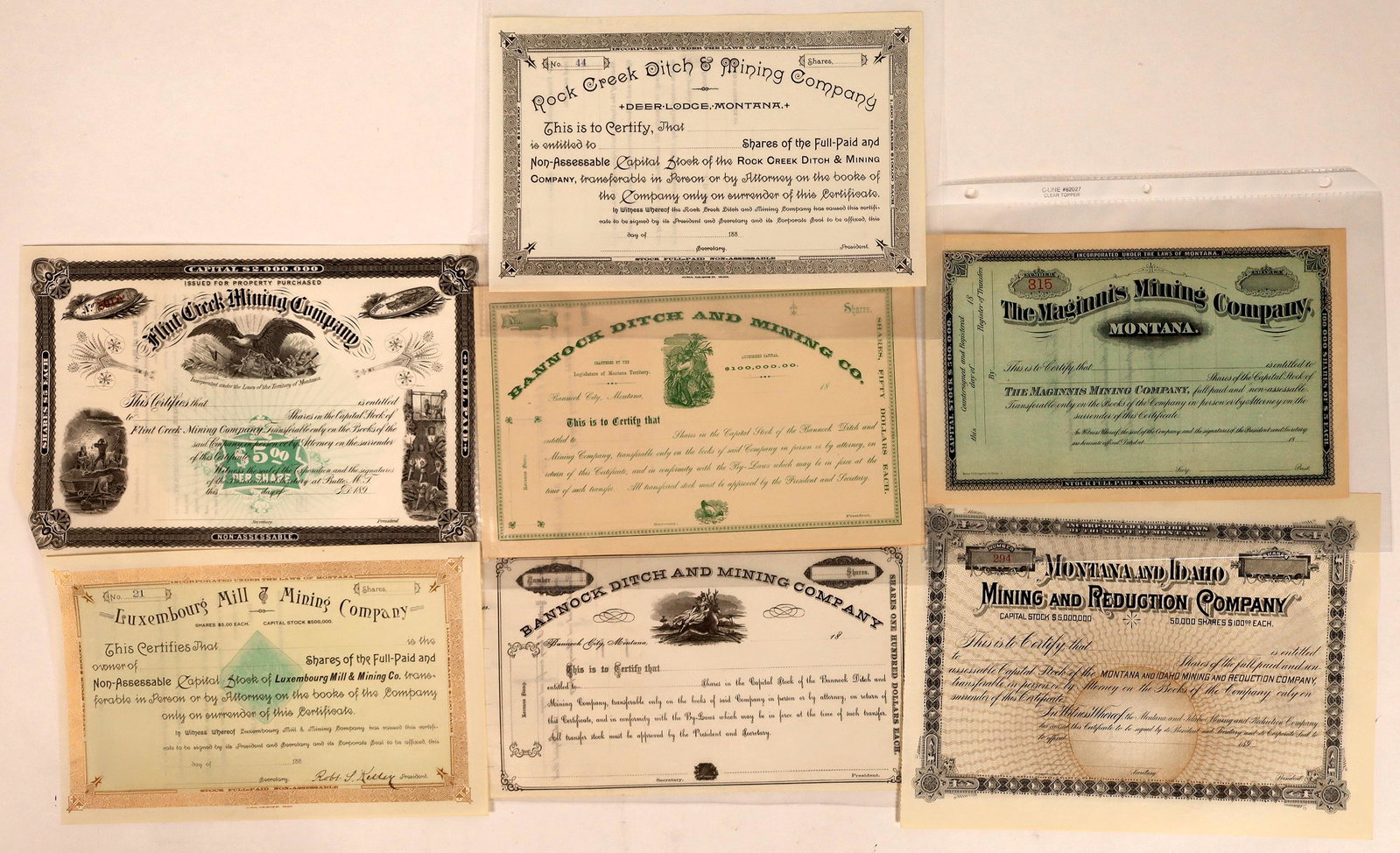 Unissued Montana Mining Stocks, pre-1900 [129571]: Lot of 7 different. While unissued, these can help fill holes in your collection. Sometimes, only unissued pieces are known. Includes: Flint Creek Mining Co. (Butee, 1890s, fabulous Morgan Dollar vign