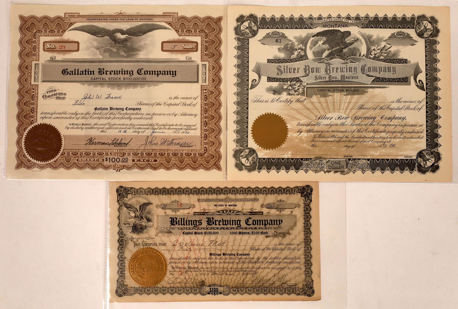 Montana Brewing Stock Certificate Trio [129627]: Lot of 3 different. Includes: Billings Brewing Company (1914, pen cancelled, eagle vignette); Gallatin Brewing Company (1933, not cancelled, eagle vignette); and Silver Bow Brewing Company (unissued,