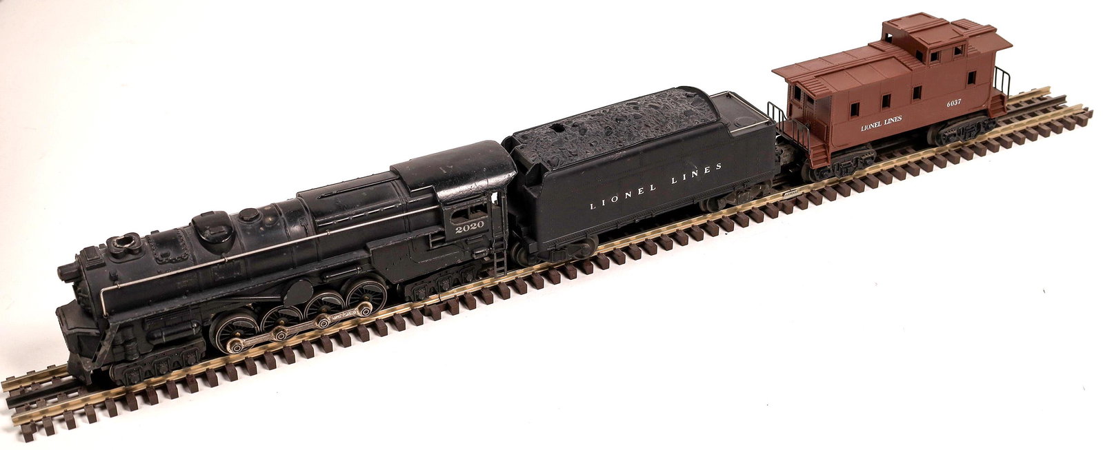 Lionel Locomotive and Tender [133016]: #2020 Loco 6-8-6 steam turbine with tender with 6-wheel trucks. "Lionel Lines", Black, with Caboose #6037. C7 condition. Runs.Date: 1947-50Country (if not USA): State: City: Provenance: Gary Nelson Ra