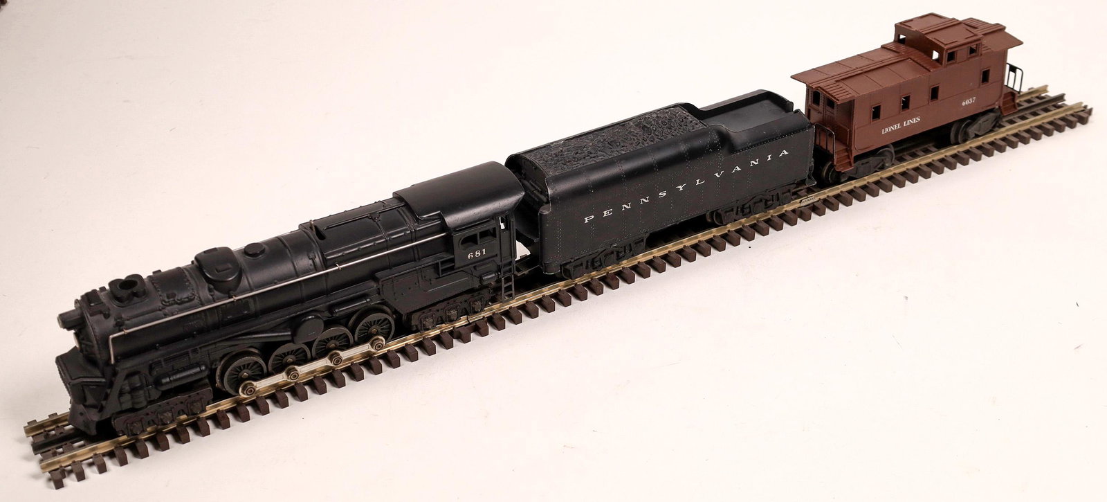 Lionel Locomotive and Tender [133017]: #681 Loco 6-8-6 steam turbine with tender with 6-wheel trucks. "Pennsylvania RR" Black. With Caboose #6037. C7 condition. Runs.Date: 1953-57Country (if not USA): State: City: Provenance: Gary Nelson R