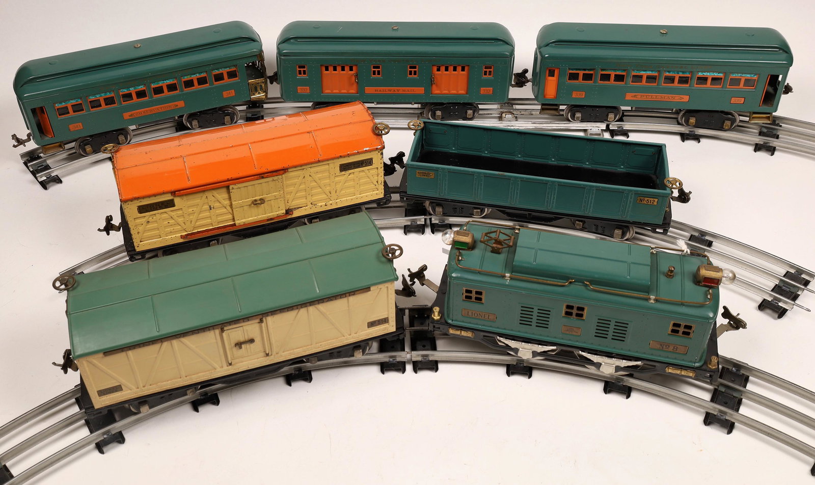 Lionel Polar Diesel and 6 Cars with Track and: #8 on both sides of Diesel, peacock in color with brass rails, glass intact. 2 Passenger cars and 1 RPO in peacock color with orange trim. 1 Gondola in peacock, 1 Box Car in yellow with peacock roof. 