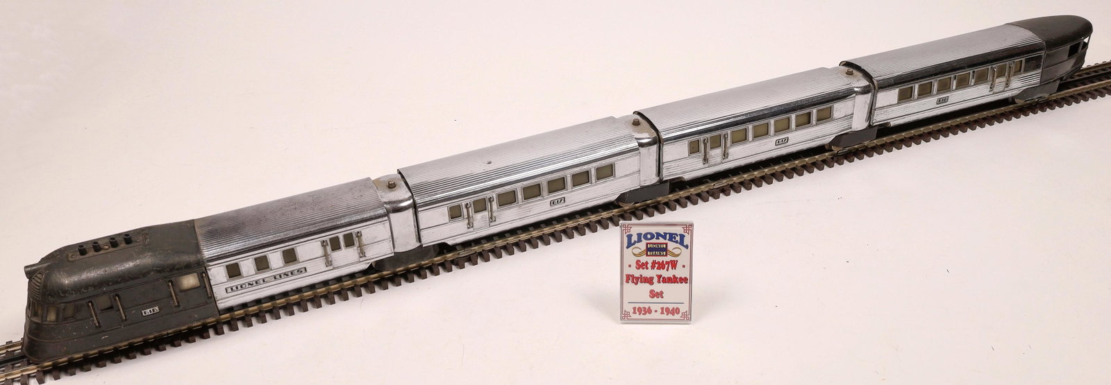 Lionel Set 267W Flying Yankee [133148]: Loco #616 Diesel Engine, black. Car 1: #617 Passenger Car Car 2: #617 Passenger Car Car 3: #618 Observation car. All silver. Observation car has black rear cab area. Window glass intact. Untested, but