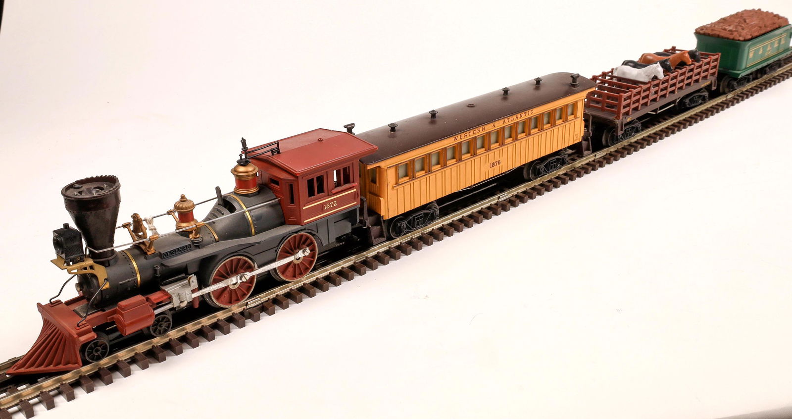 Lionel Steam "The General" Locomotive and 2 Cars: #1872 Loco 4-4-0. "General" on both sides of boiler, gray with black stack, tuscan wheels, pilot in cab and brass trim. Green Tender marked W&A.R.R. #1872T Simulated wood. Car 1: Mail Baggage Car #187