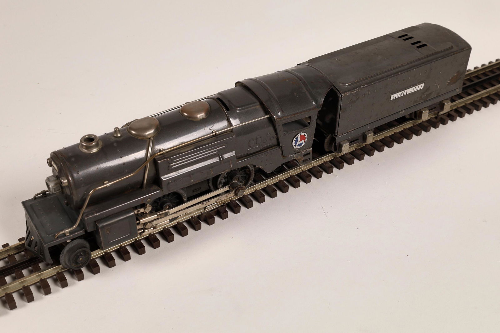 Lionel Tin Plate Locomotive and Tender [133051]: #259 Loco 2-4-2, Tender "Lionel Lines", gray. Red and Blue Lionel logo on cab. C7-8 but not box.Date: 1932Country (if not USA): State: City: Provenance: Gary Nelson Railroad Collection