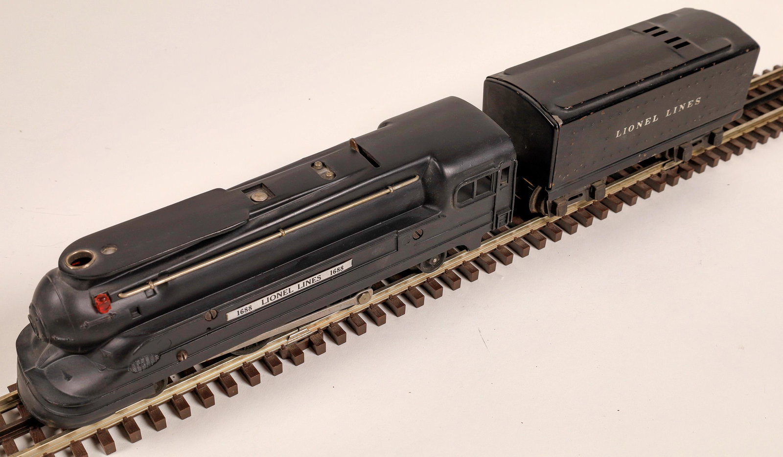 Lionel Torpedo Locomotive and Tender [133052]: #1688 Loco 2-4-2, Tender "Lionel Lines". Black with red markings on nose. Linked couplers. C7Date: c1940Country (if not USA): State: City: Provenance: Gary Nelson Railroad Collection