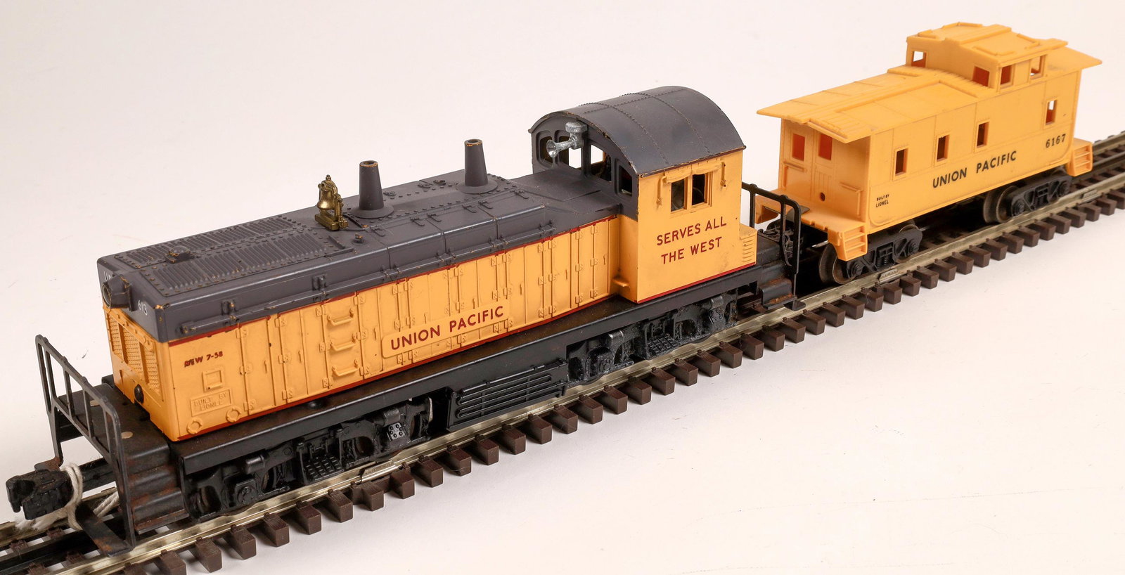 Lionel Union Pacific Switcher and 1 Car [133130]: Yellow and gray with red stripe and printing, Caboose #6167 marked Union Pacific. C7. O-scale. Operational.Date: 1955-62Country (if not USA): State: City: Provenance: Gary Nelson Railroad Collection