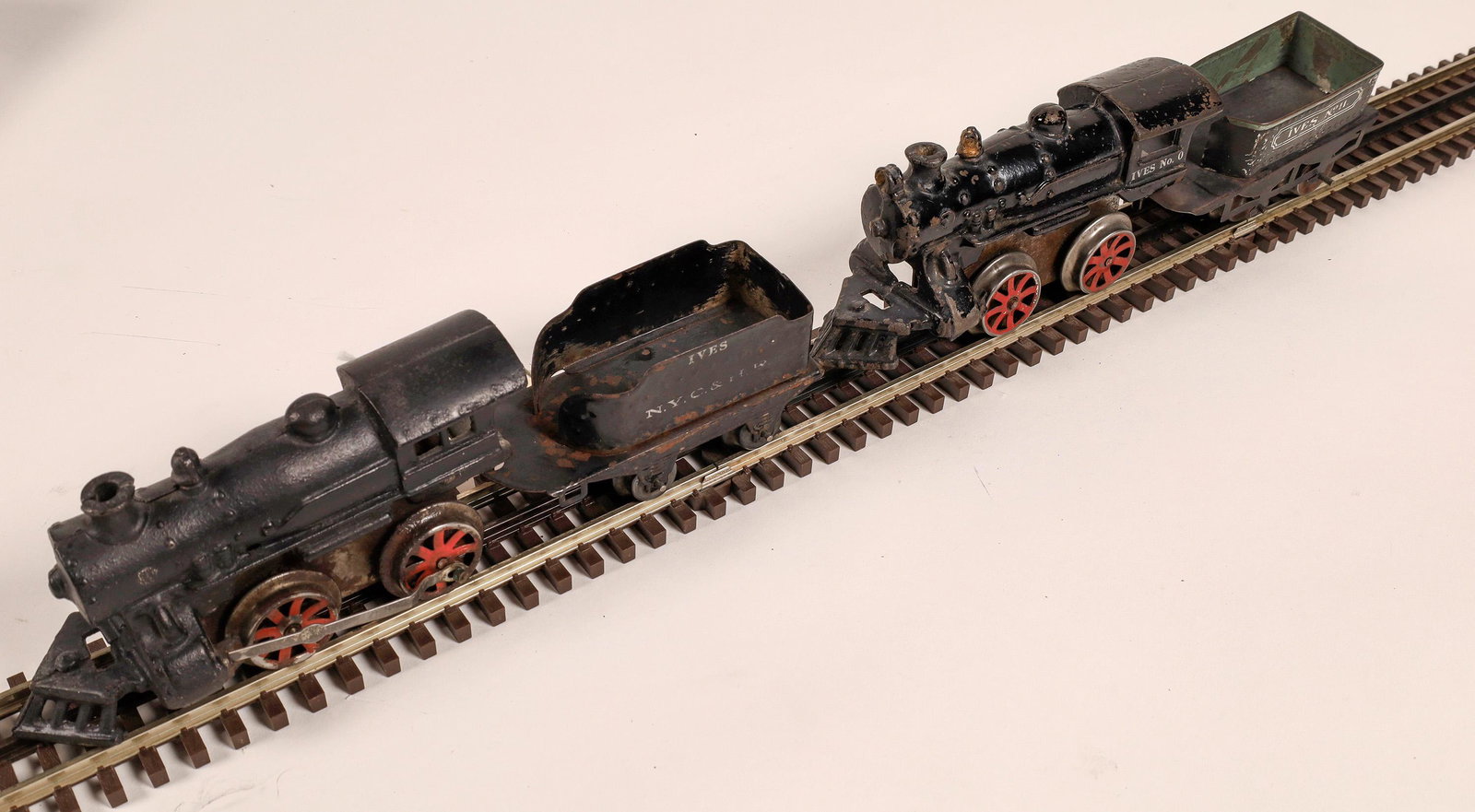 Wind-Up Locomotive and Tenders - 2 [133074]: 1) Cast iron wind-up locomotive, black and red. Tenders are tin, NYC & HR. Ives. 2) Cast iron, black wind-up locomotive, red wheel, tender Ives #11. No damage. Good condition.Date: 1900-1920Country (i