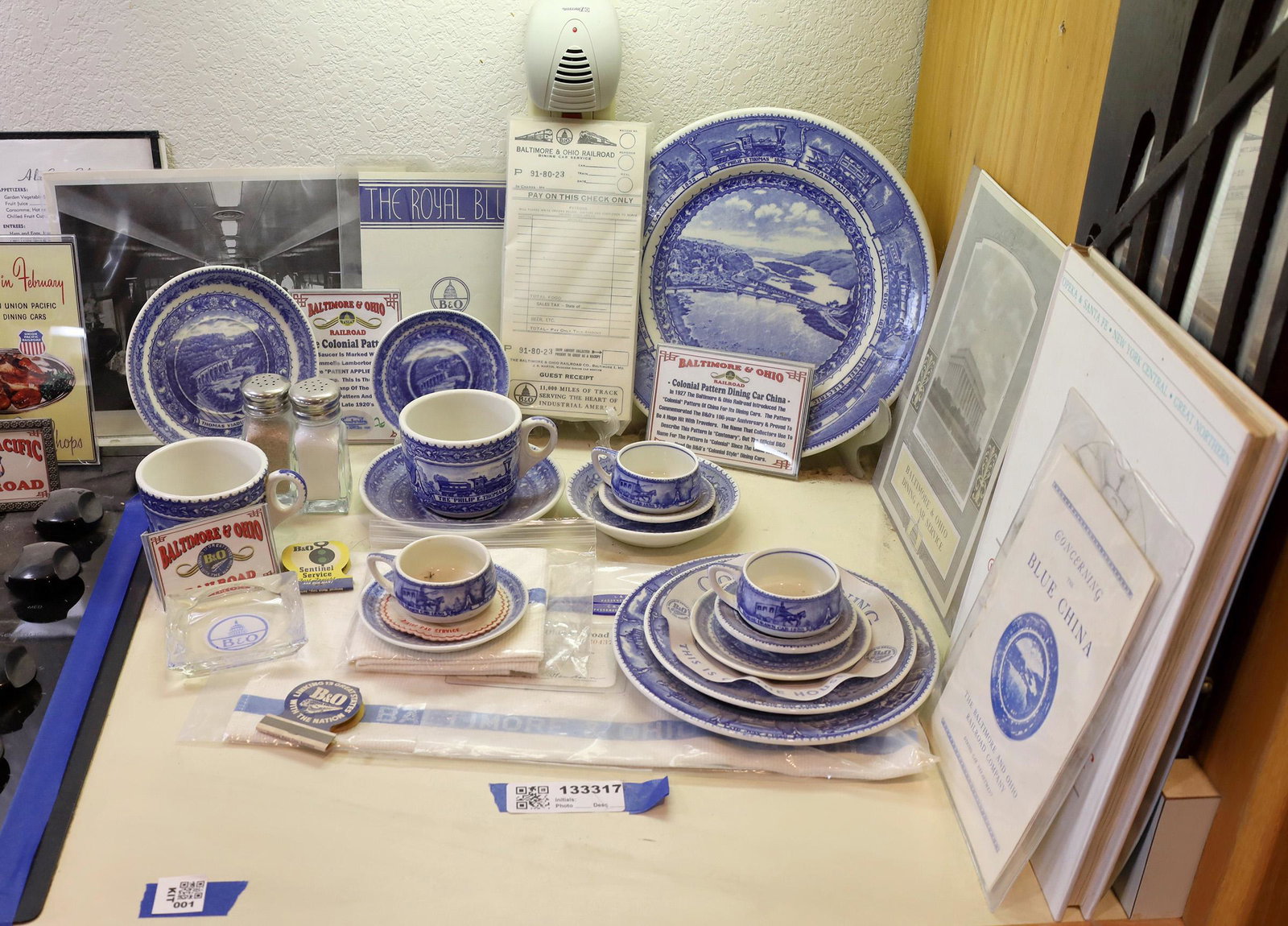Baltimore & Ohio RR Dining Car China - Colonial Pattern: Lot includes 14 pieces of serving china from the Baltimore & Ohio RR dining car; a menu and other ephemera; a towel; and 2 booklets "The Blue China of the B&O RR Co." Collection includes everything fr