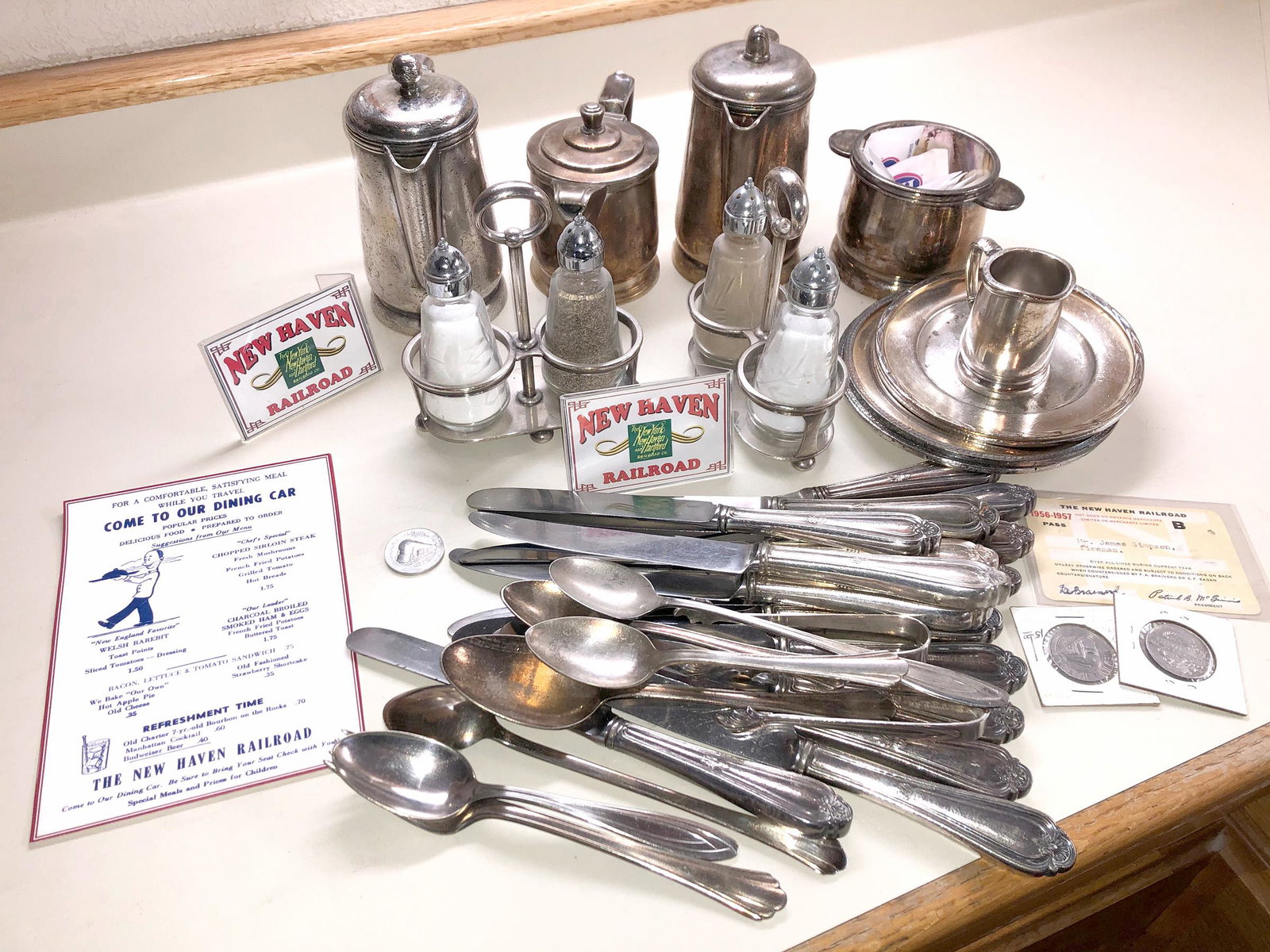 New Haven Railroad Dining Car Silverplate, Flatware,: About 25 pieces of flatware, all marked; creamer, tea pot, coffee pot, and 2 salt pepper shaker pairs, and holder All punched New Haven RR on the bottom, all silverplate Lot comes with 1956 pass and 1