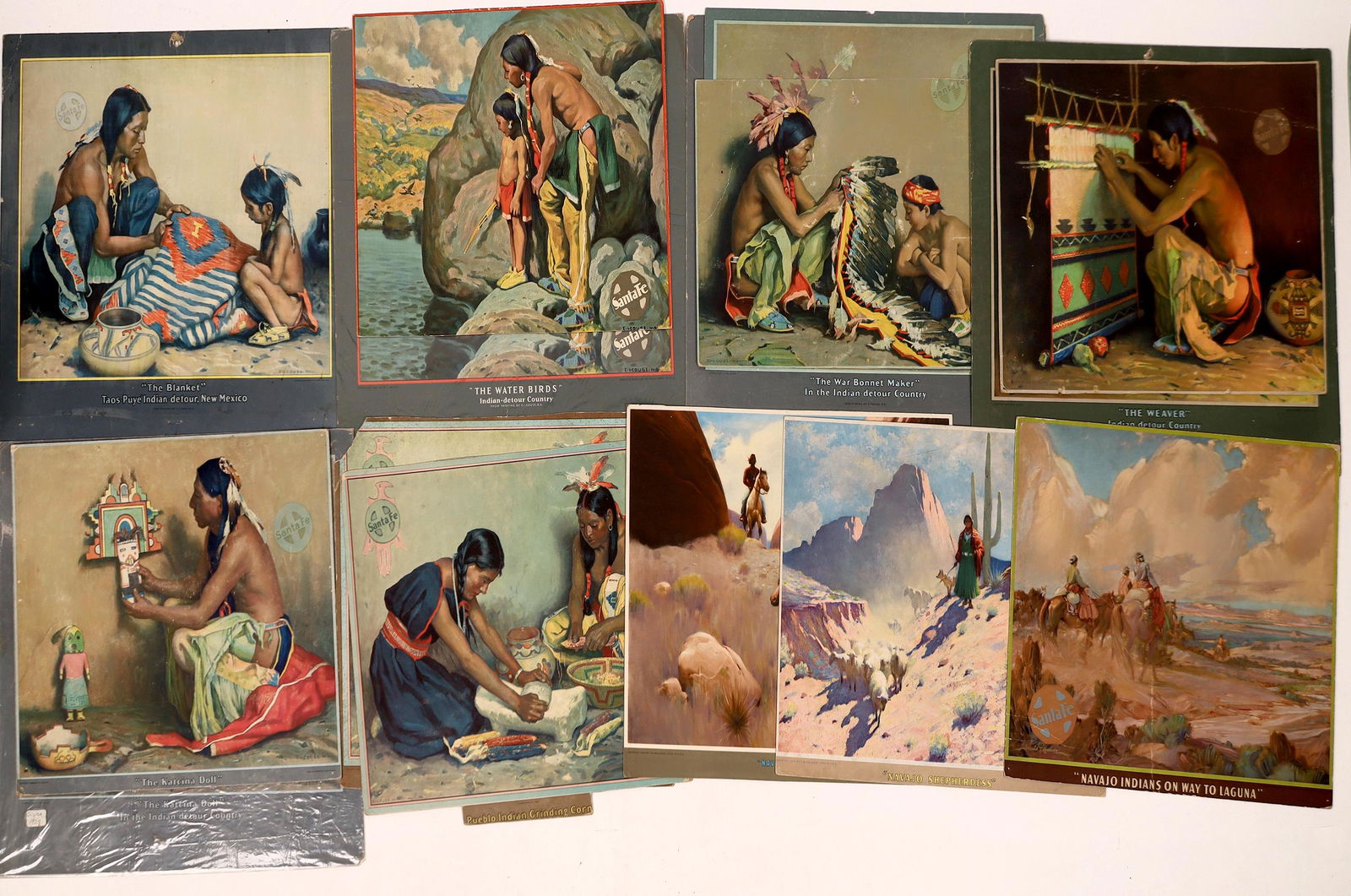 Santa Fe RR Calendar Art -1926-1945 - 15 pcs [126904]: Fifteen calendar art pages, published between 1926 and 1945. Includes the following: 1926, E.I. Couse, Pueblo Indian Grinding Corn (closely trimmed, two copies); 1929, E.I. Couse, The Blanket (untrimm