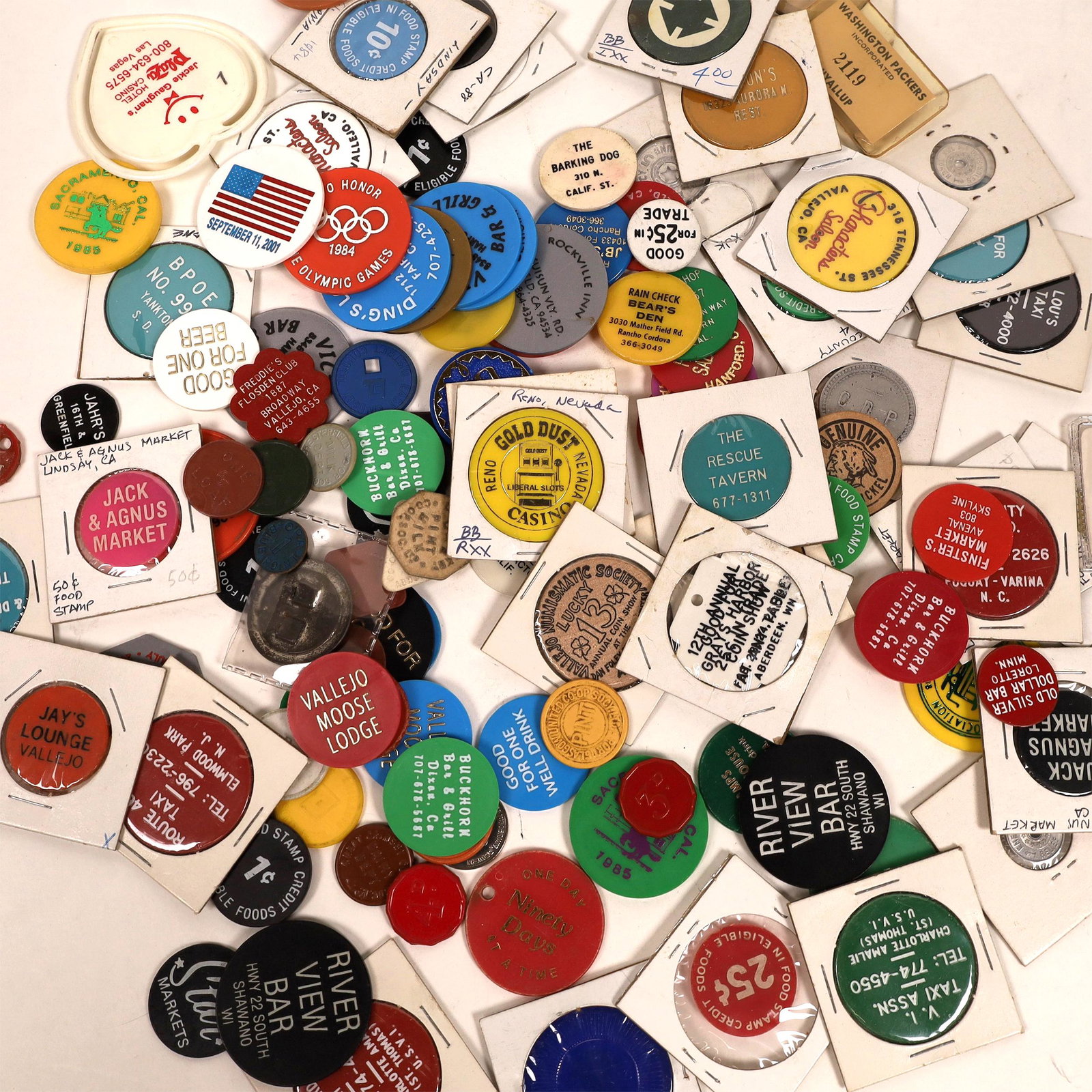 Plastic Token Grab Bag [129977]: Approx 75 pieces of unsorted tokens, mostly from California. Includes pieces such as Character Saloon in Vallejo CA, Blue Beards Taxi, Lou's Taxi, Georges Den, Yankton Lodge, Jack & Angus Market, vari