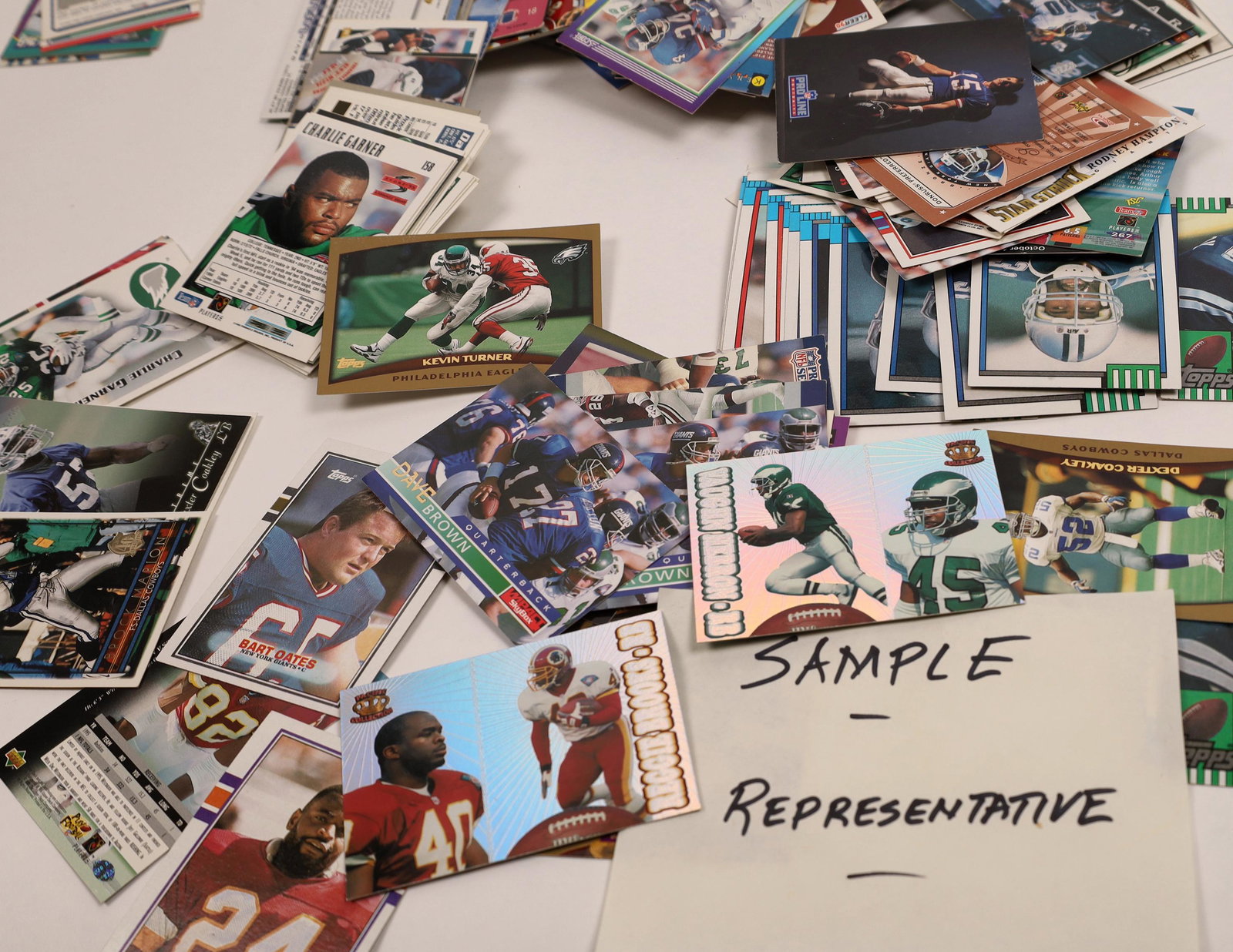NFL NFC East Trading Cards [131109]: An assortment of approximately 200 Topps, Fleer, Upper Deck and more trading cards, featuring players from the NFL's National Football Conference East. Players featured include Phil Simms, Jeff Hostet