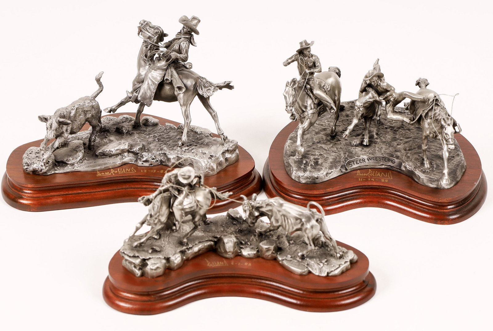 Cow Roping Pewter Statues (3) [129971]: Lot of three statues about 5-6" tall. 1.) Steer Wrestling. 1978 Polland, Autographed 11-14-85. 250/2500. 2.) Hightailin' 1988, signed by Polland 1988. 283/2500 3.) Maverick Calf, 2297/2500, 1974, Sign