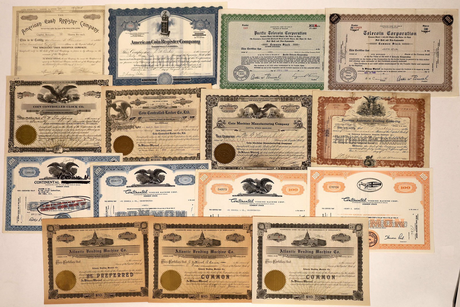 Cash Register and Coin Vending Machine Stock Collection: Lot of 14 certificates from coin-op busineses: American Cash Register; American Coin Register Company; Pacific Telecoin; Coin Controlled Clock Company; Coin Controlled Locker Co.; Coin Machine Manufac
