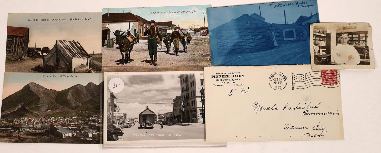 Tonopah Post Card Collection [128323]: Five real photo post cards of Tonopah: "Jim Butler's Tent," typical prospectors (1909 postmark) "The Bottle House," birds eye view, "moving into Tonopah." 1922 postal cover from the Pioneer Dairy; 190