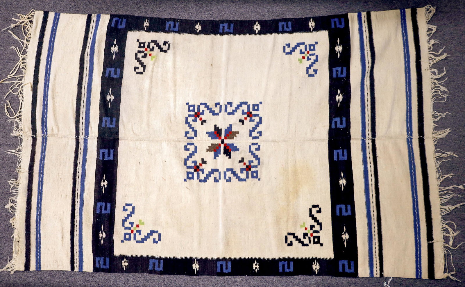Southern Arizona Blanket [109487]: Blanket made of wool. According to an expert at Antique Roadshow, the blanket was made by Indians from Central America who migrated to Arizona. This blanket is stained in the beige area of blanket. Pl