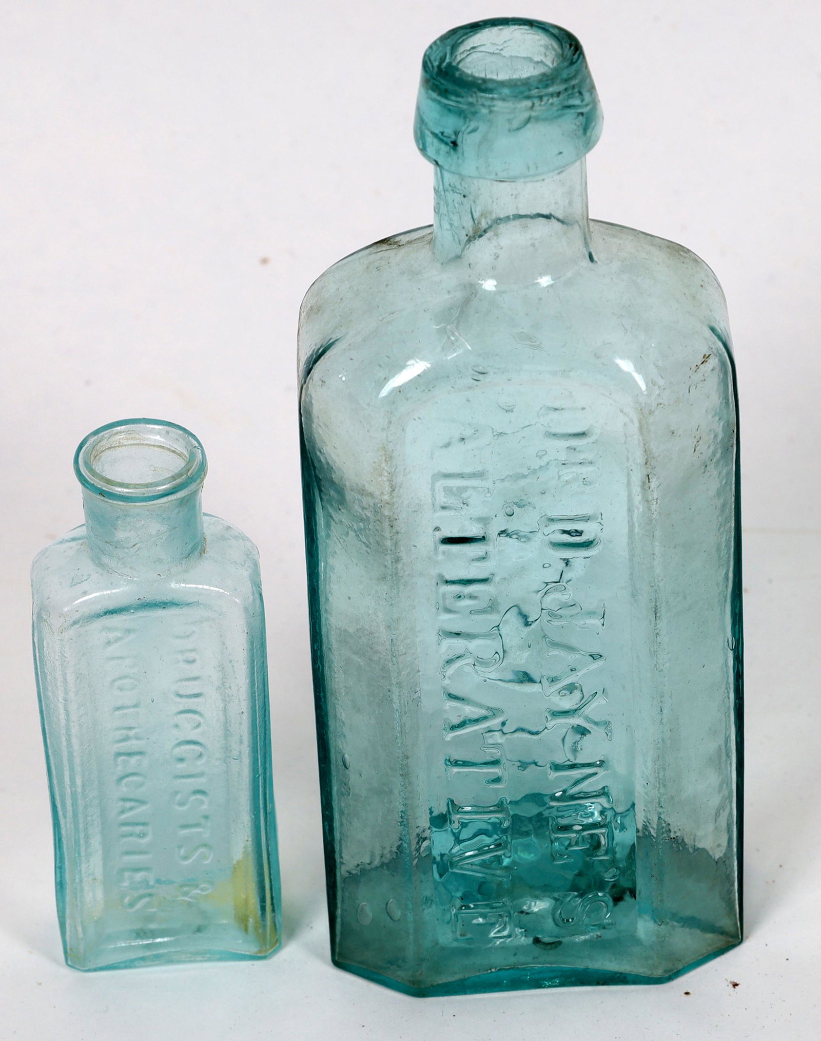 Rare Open Pontil Philadelphia Medical Bottles (2 Each): Both bottles are unlisted in Mitchell 2008. 1. "Dr D. Jayne's / Alternative // Philad" 5 7/8" tall. 2 5/8" wide. 1 5/8" thick. Heavily whittled, aqua, near mint. 2. "Wiltberger & Bro. // Druggists & /
