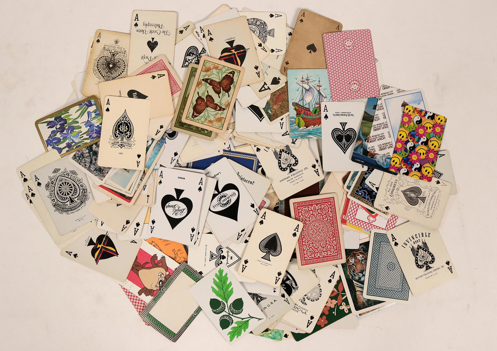Aces playing cards collection c.1930-1990's [135397]: This is a collection of playing cards; all aces and mostly ace of spades. Over 50 cards in all, from around the world..Date: Country (if not USA): State: City: Provenance: