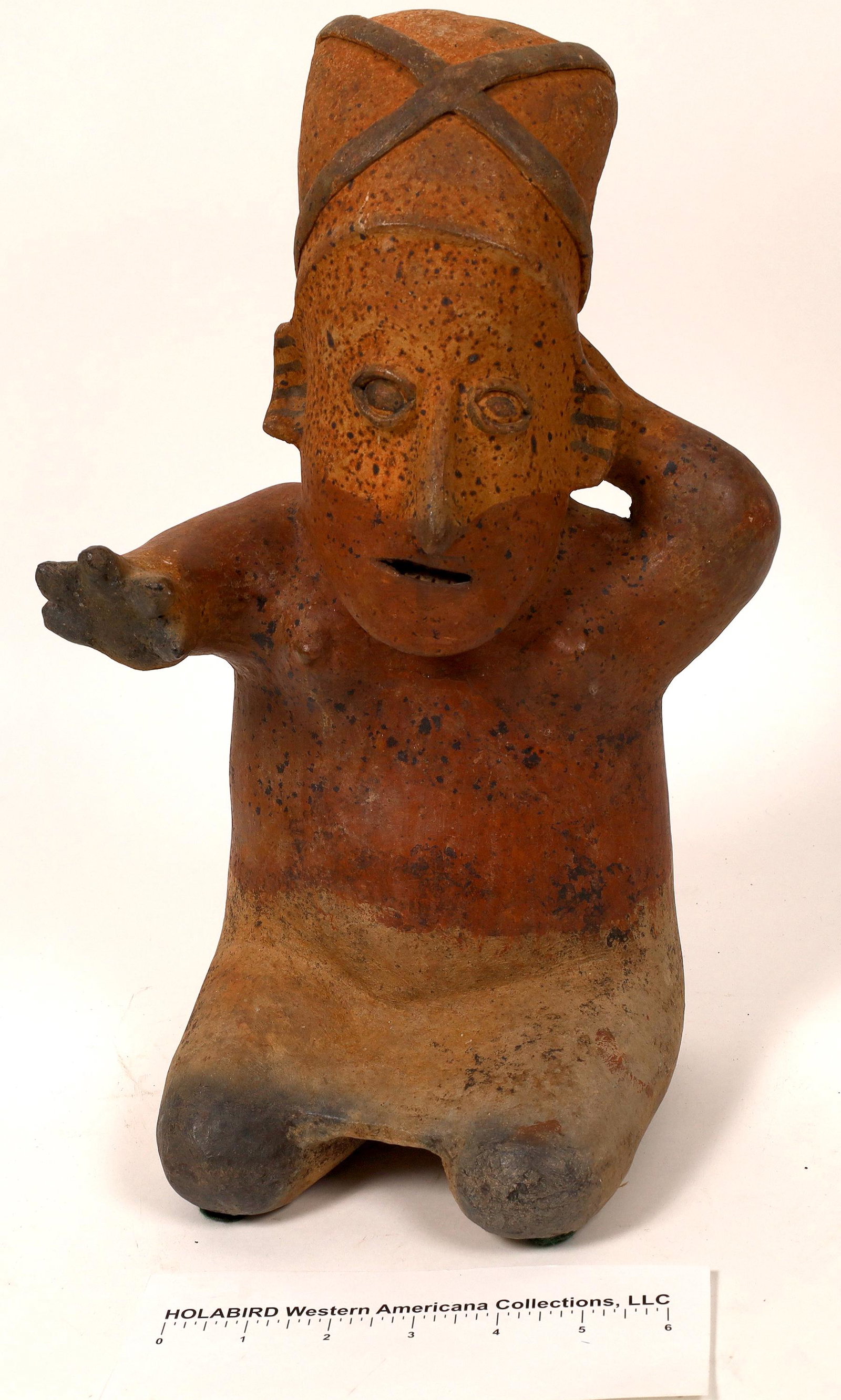 Nayarit (?) Human Figural Terra Cotta Sculpture: 15" tall x 10" across by 8" deep. Hand made clay sculpture of woman with tall bundle on her head in sitting position. Some original red paint adorns the body from stomach to shoulders and bottom of fa