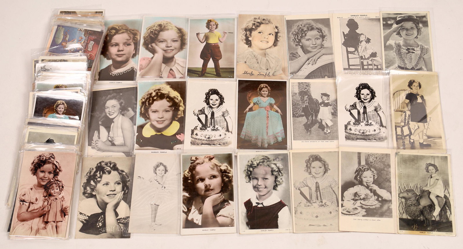 Shirley Temple Postcard Collection [140989]: Lot of over 100 Shirley Temple postcards. Her smiling face, her home in Brentwood Heights, her figure in the Movieland Wax Museum, posing with Shirley Temple dolls. All stages of her acting career. Bo