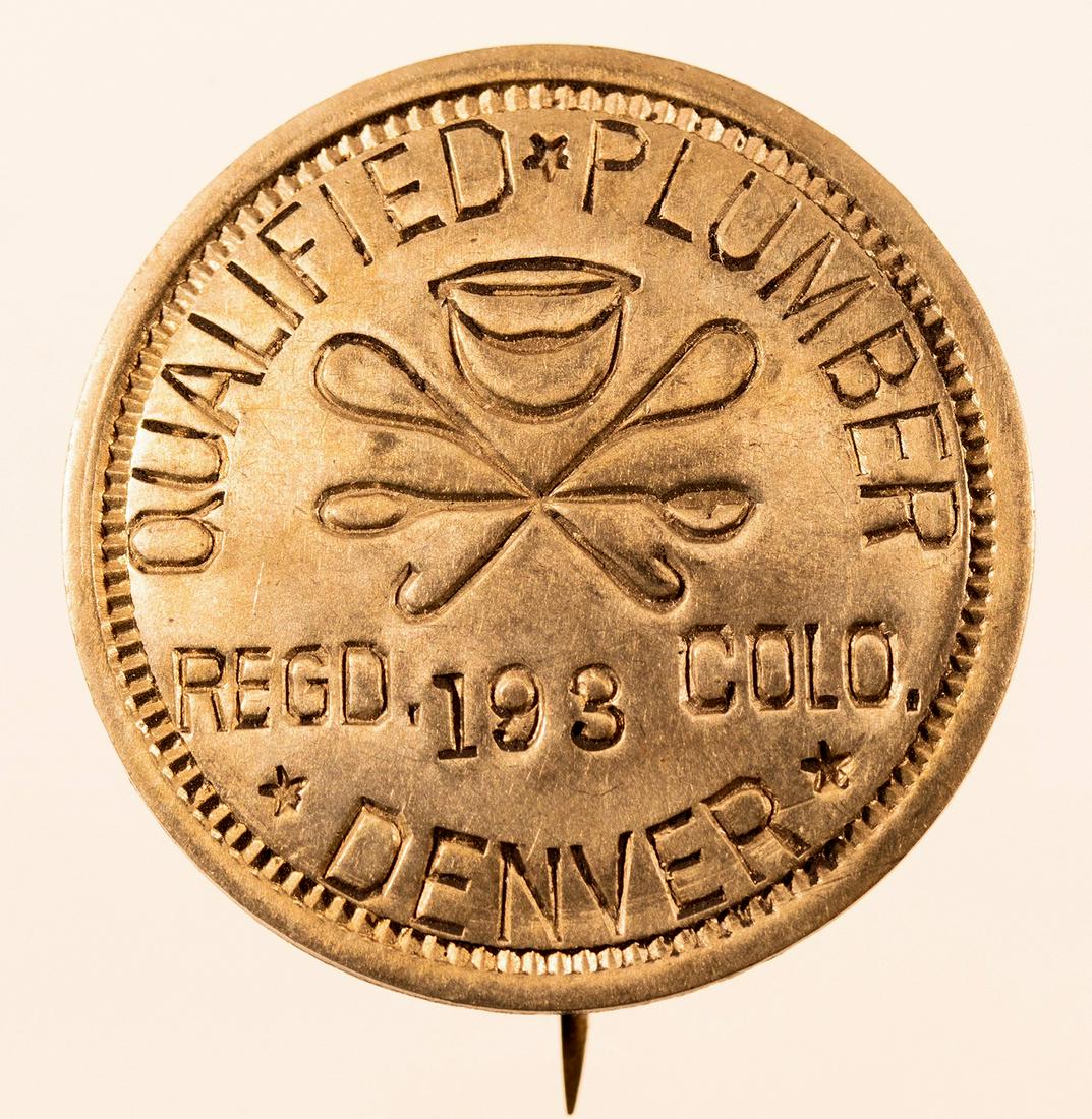 Denver, CO Plumber Badge [152093]: Round white metal plumber badge. Qualified*Plumber, Regd. 193 Colo., DenverDate: Country (if not USA): State: ColoradoCity: DenverProvenance: Gary Bracken Collection