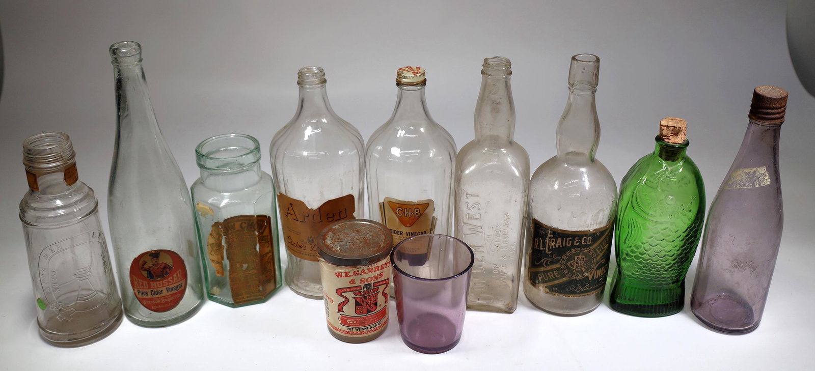 Food Jar and Bottle Group, 55 [155018]: About 55 food bottles and jars, c. 1950's to 1960's.Red Hussar Pure Cider Vinegar with paper label, Golden West Oil, Fr. Fischs Bitters, RL Craig Pure Cider, several Folgers Coffee, Glen Valley Catsup