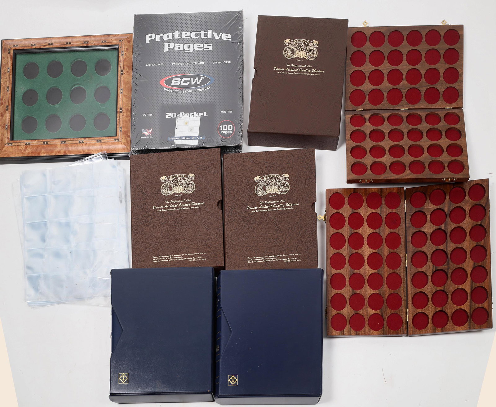 Coin Collecting Supplies [154639]: Two bankers boxes full of coin collecting supplies. About fifty soft cover albums to hold 60 coins each in 2 x 2 flips; five Dansco albums with slip covers: National Park Quarters, and just "Coins"; t