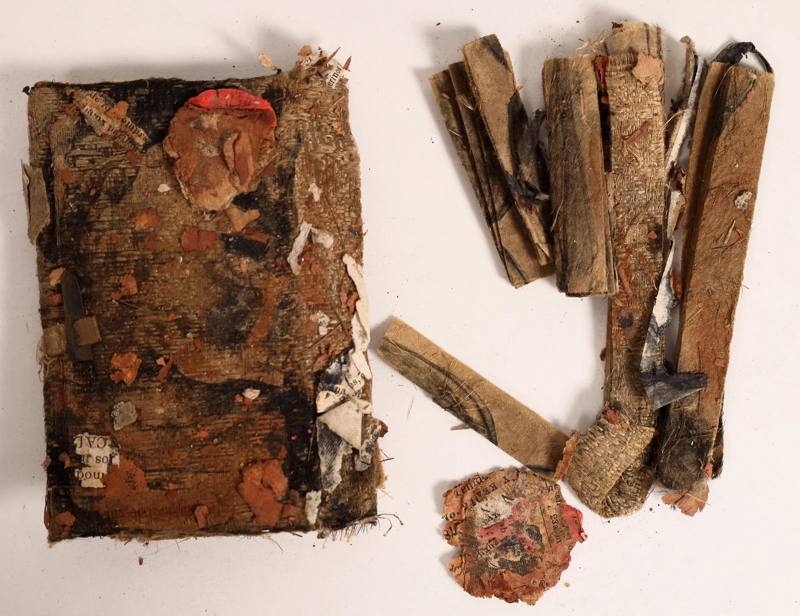 Book Fragments, SS Central America Treasure [160811]: Book Fragments found on the SS Central America. There is some Spanish text in the pieces. Approximate measurements 3.5 x 2 inches. Two red, possible wax, seals approximate 1 inch in diameter. Fragment