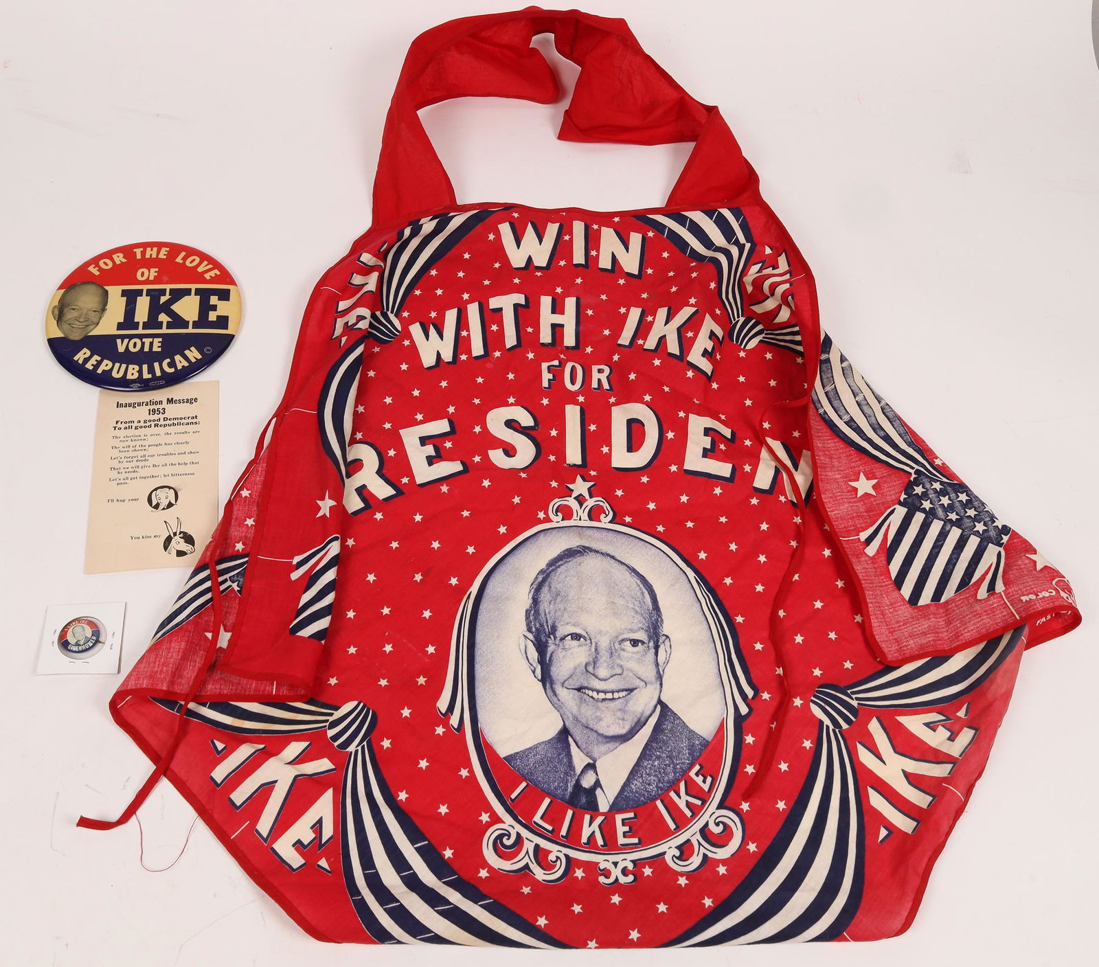 "Ike" Political Suite [161739]: Ike bling pin 1.25". I Like Ike button 1". For The Love Of Ike large button 6". Cloth red apron, Win With Ike For President 45x38".Date: Country (if not USA): State: City: Provenance: